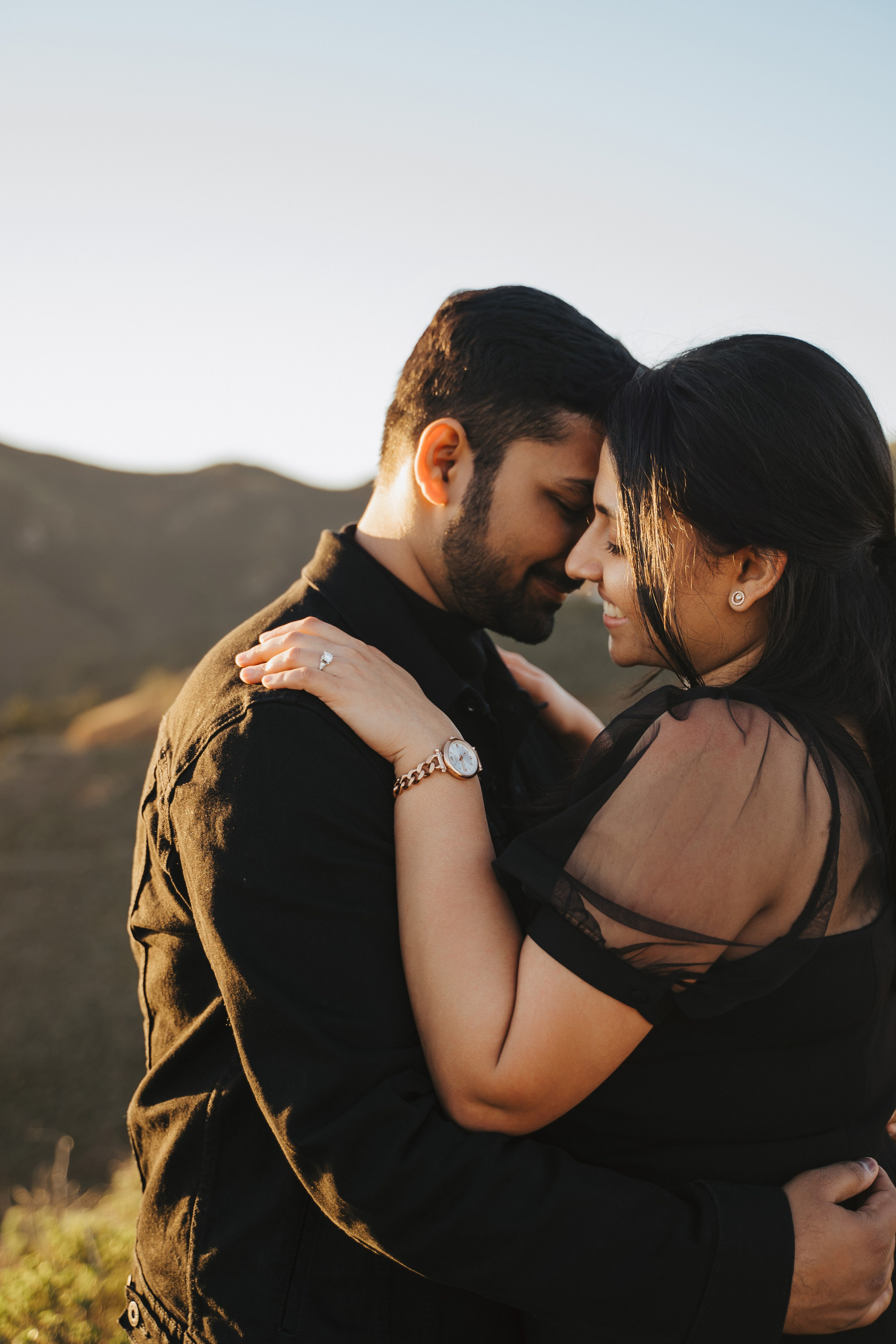 Proposal.  Overlooking the golden San Franisco Bridge sunset with a couple. Photographer Video. 