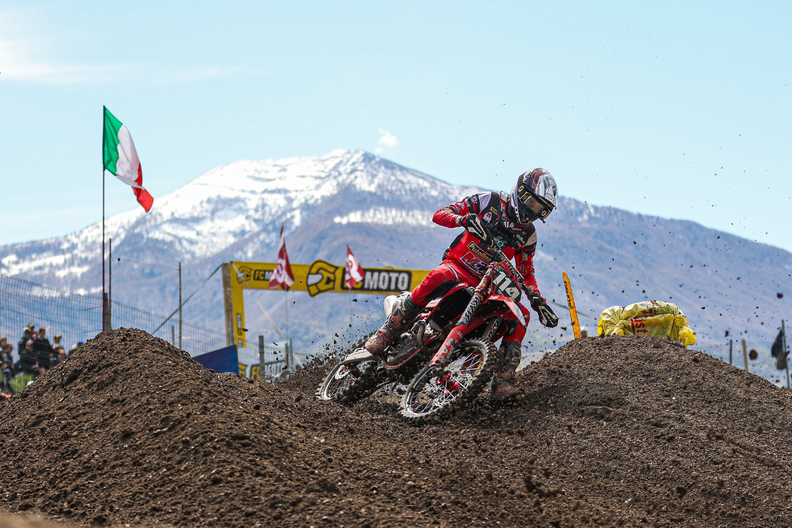 MXGP rider with the italian flag and dolomites mountains in the background Motocross World Championship