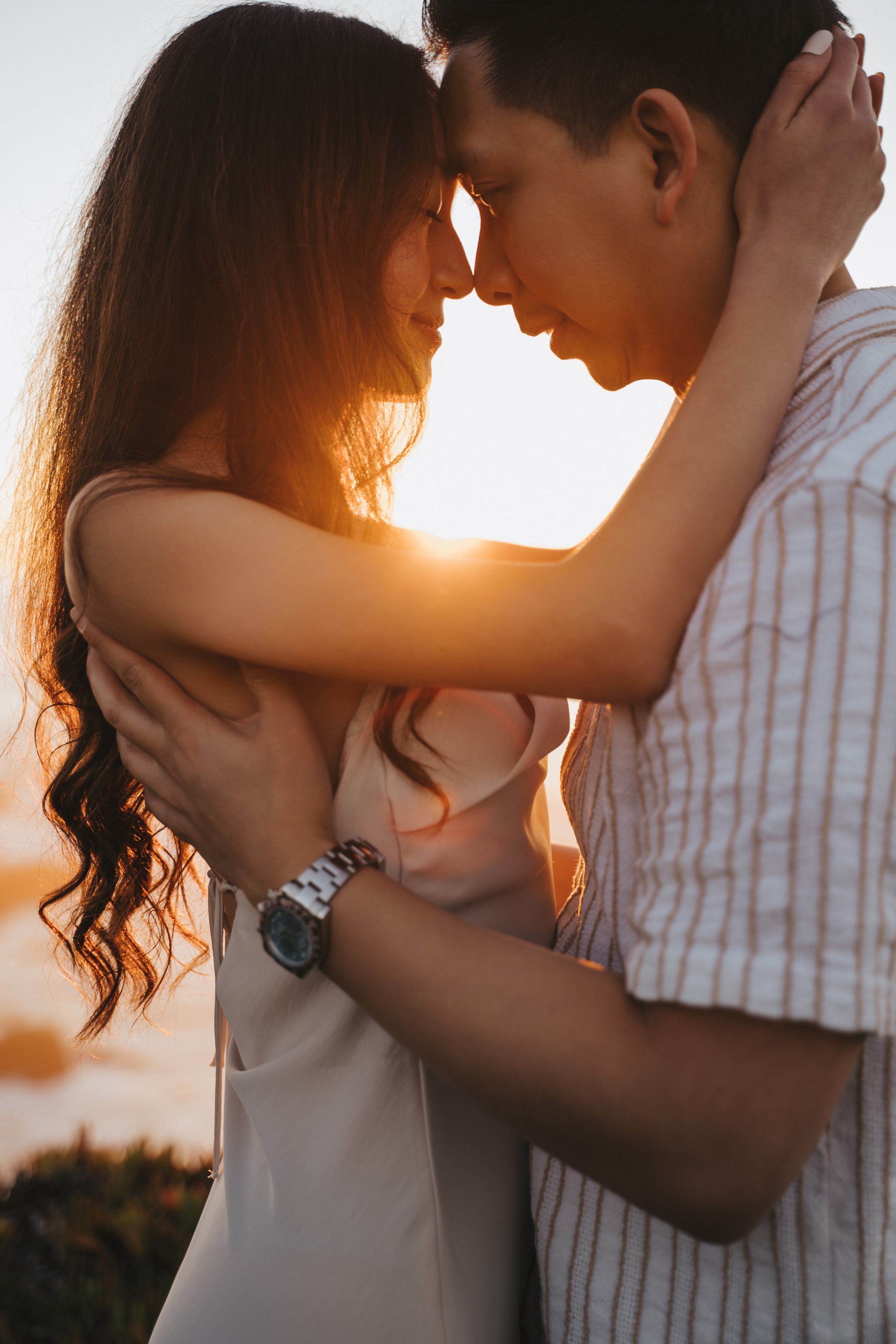 A photo shoot on the San Francisco beach at sunset. Engagement session. 