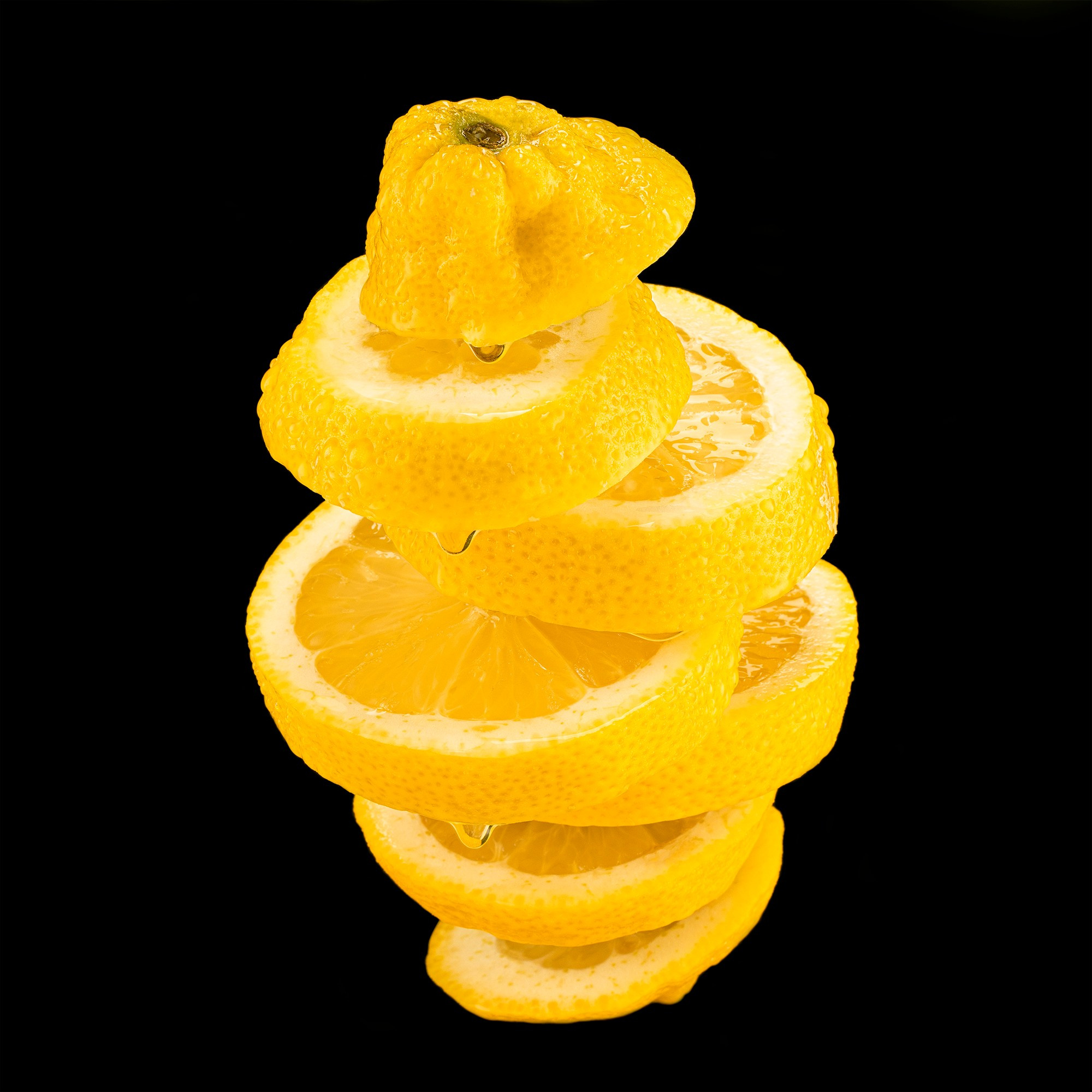 Photographer Roman Djuzev - Levitation of cut lemon on a black background.