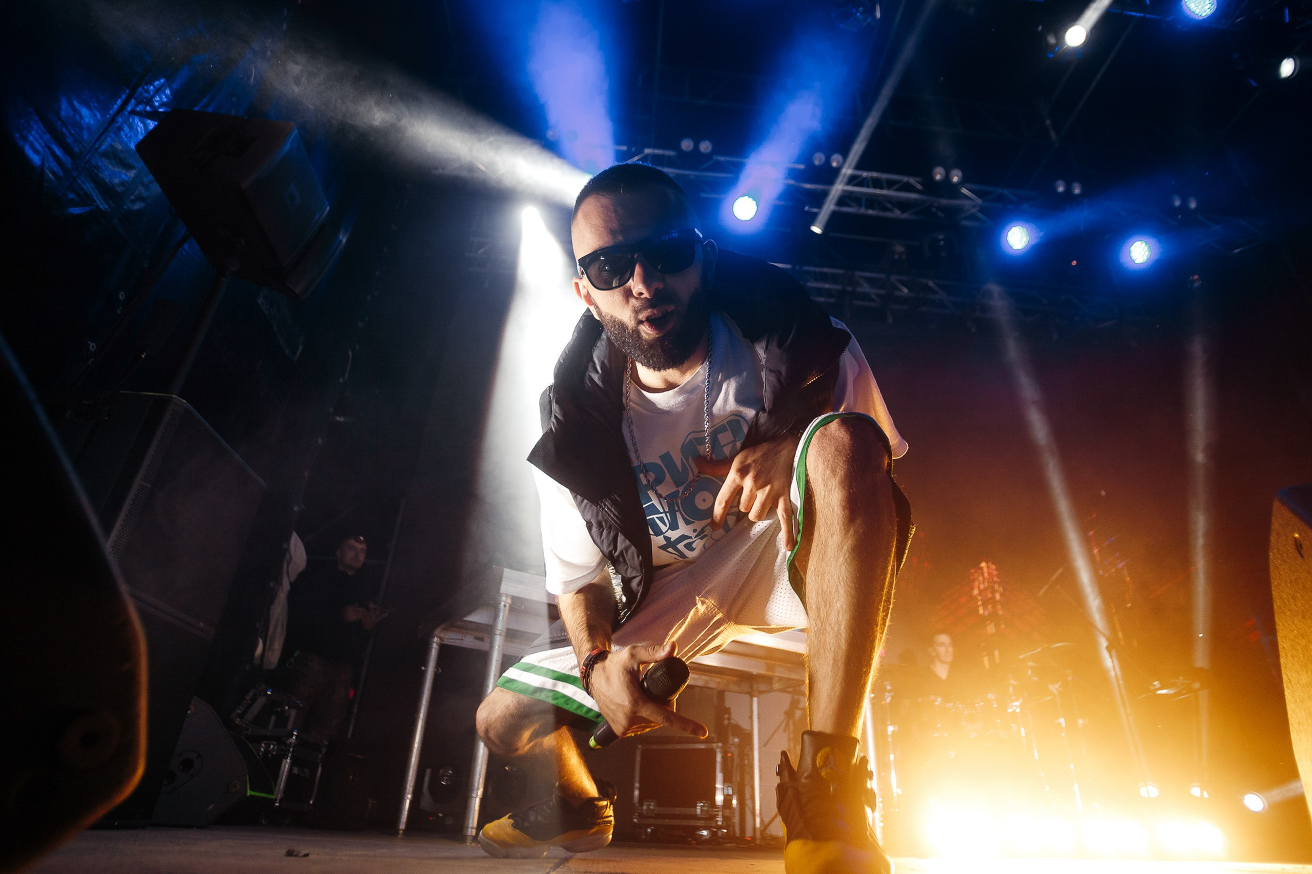 Female performer singing under dramatic stage lights