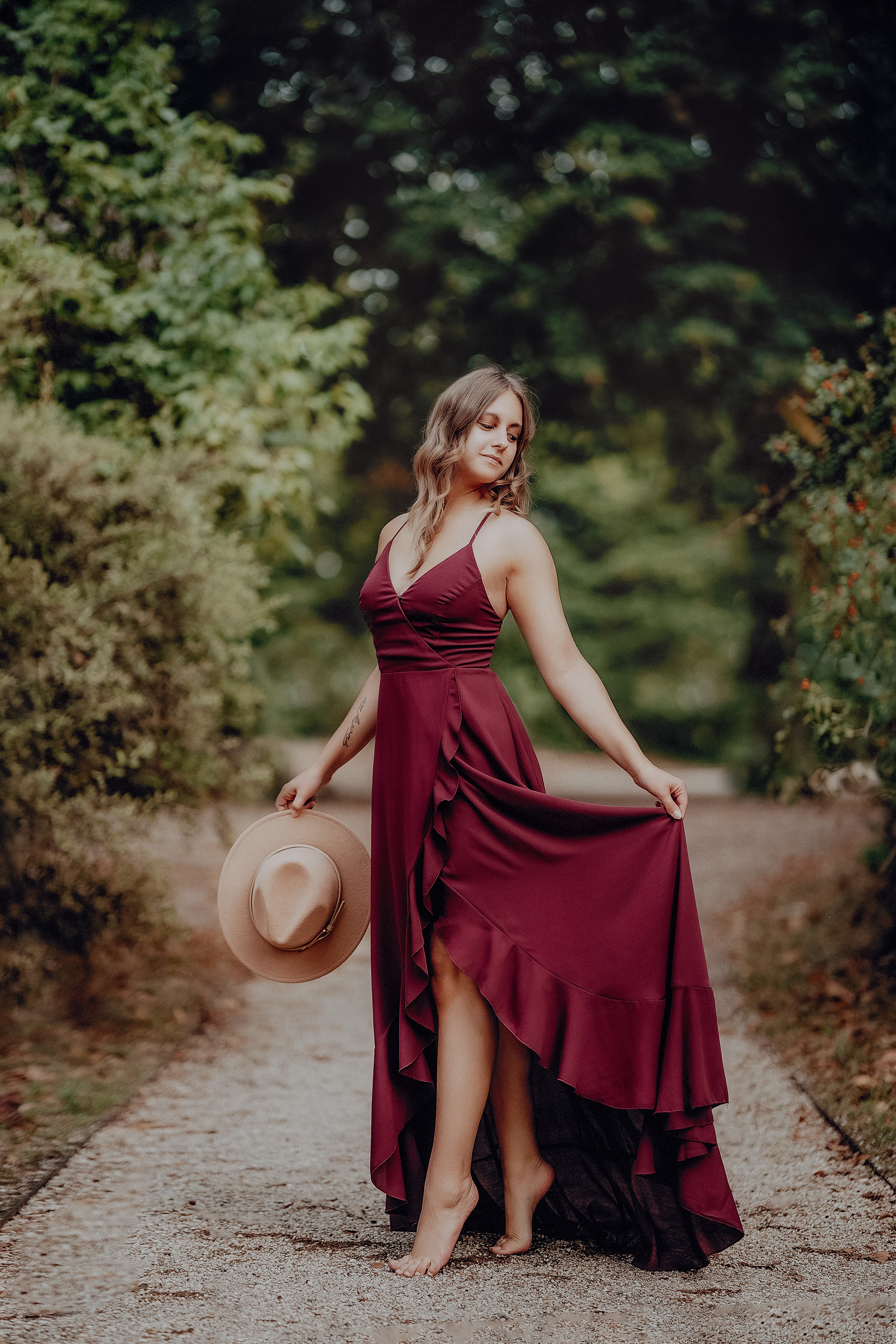 Junge Frau im herbstlichen Park im roten Kleid 