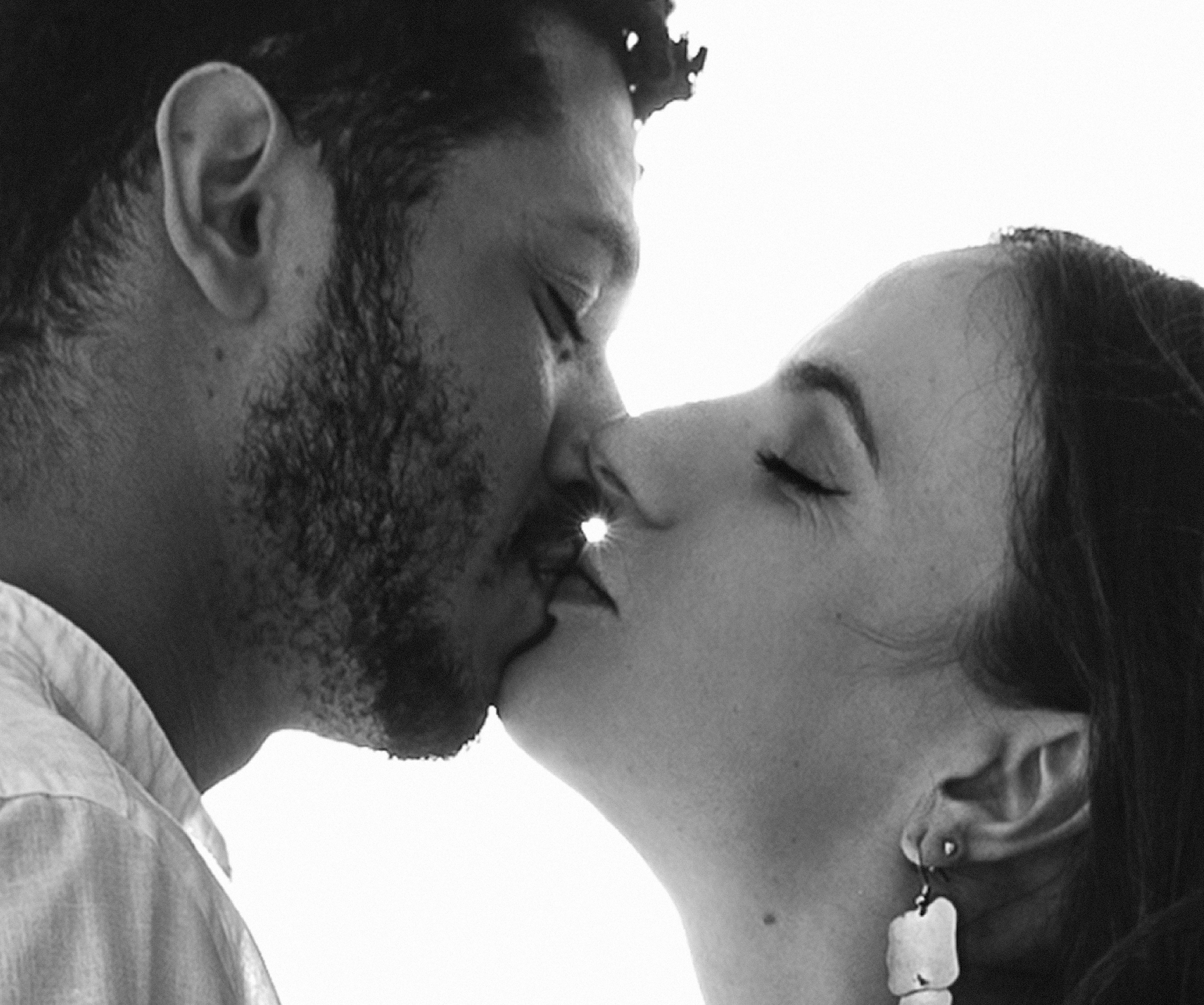 Close-up black and white couple kiss portrait taken in Madrid, Spain — capturing a tender and emotional moment of connection, ideal for those searching for intimate love story or couple photoshoots in Madrid and romantic photography experiences in Spain.