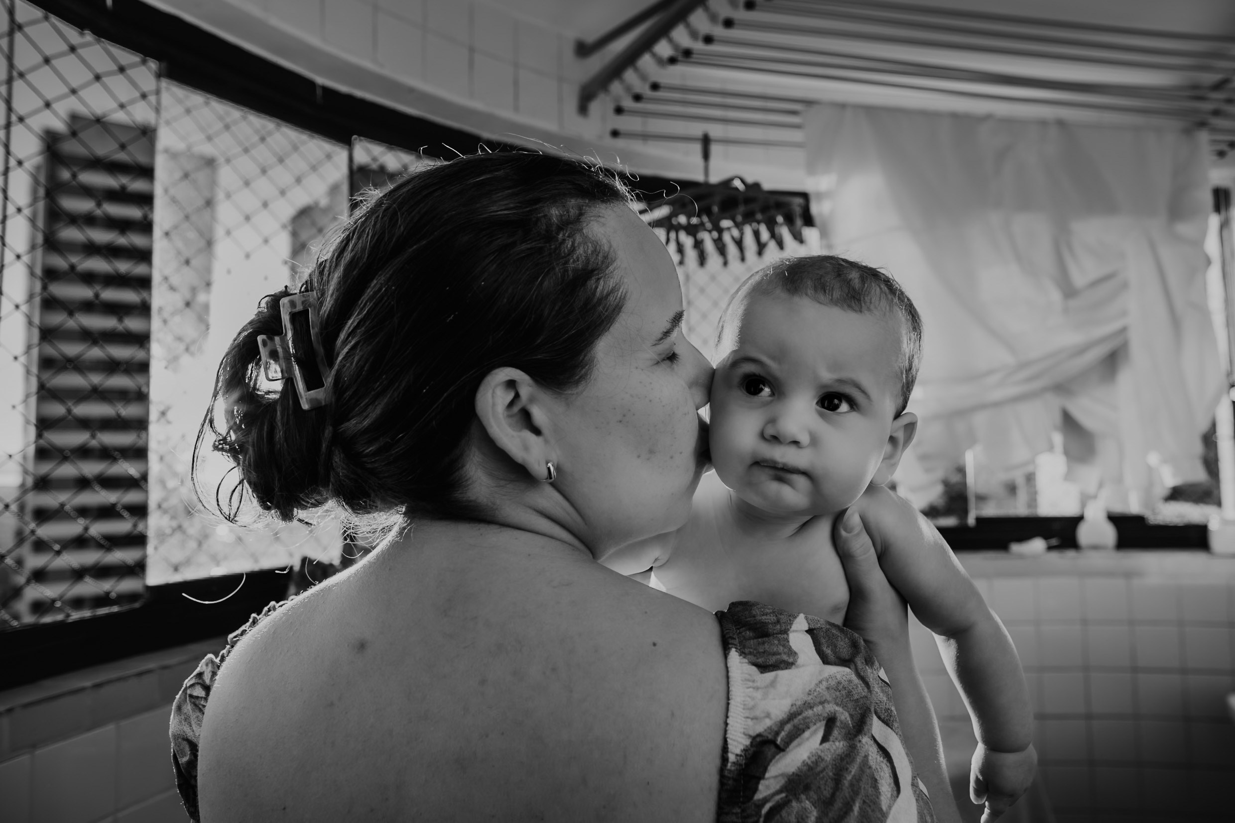 Mãe e bebê brincam juntos em uma tarde de rotina.