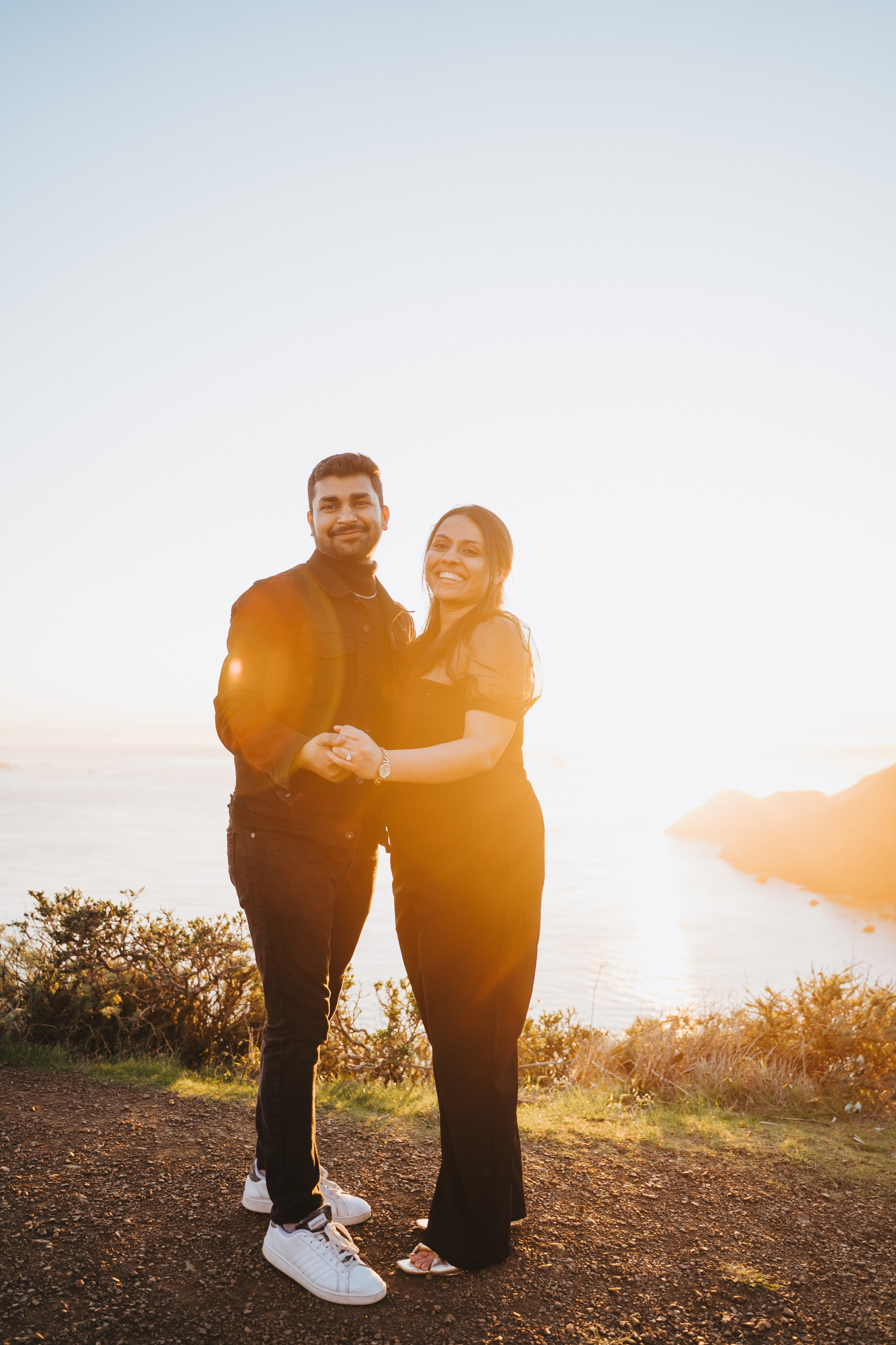 Proposal.  Overlooking the golden San Franisco Bridge sunset with a couple. Photographer Video. 