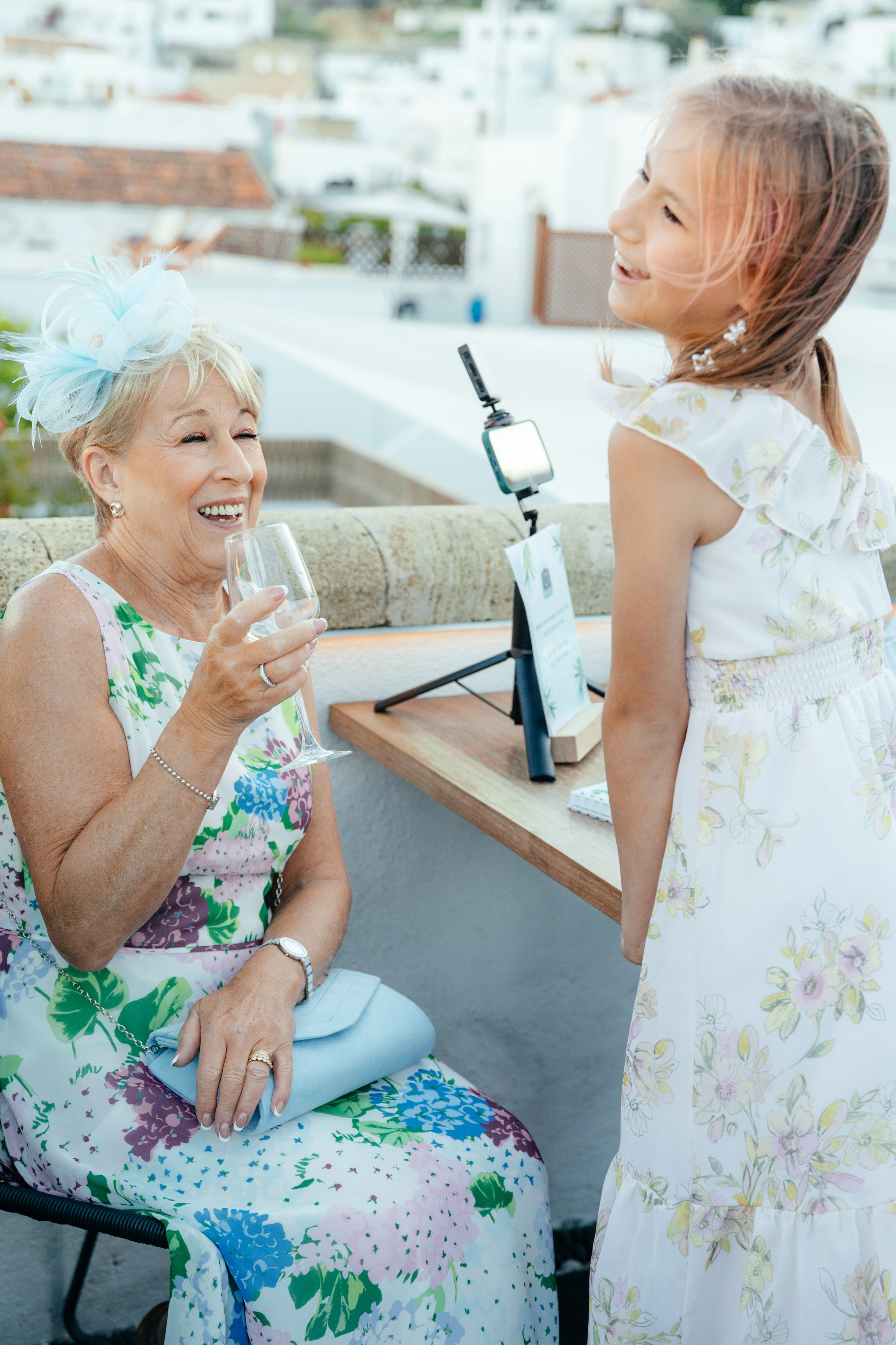 Candid moment of the guests laughing together at a wedding in a rustic bar in Lindos, Greece.