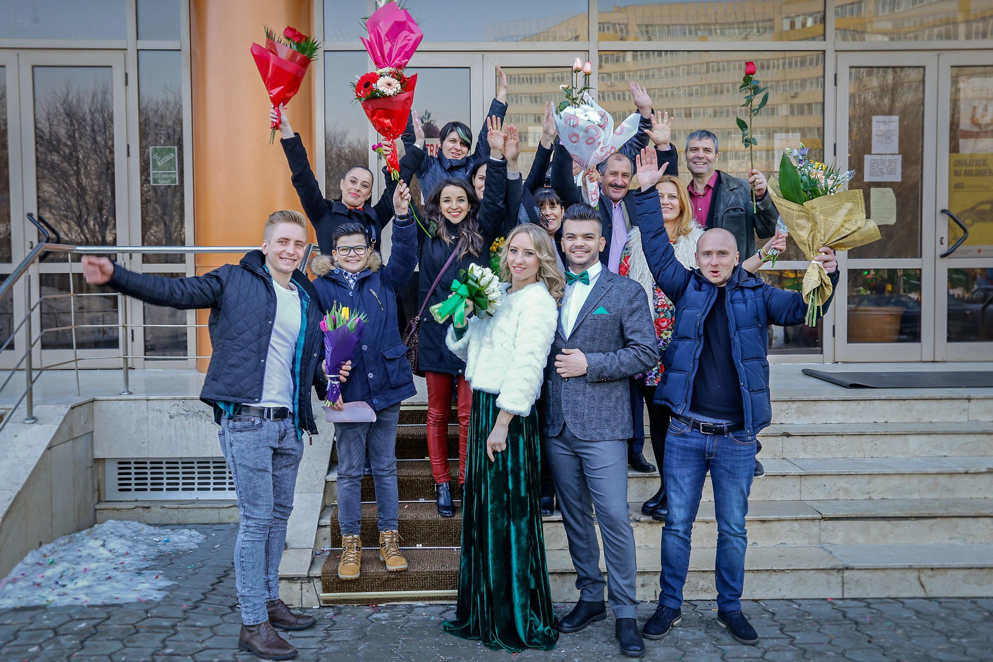 Large group photo with the newlyweds and all their guests on the town hall stairs after a beautiful winter civil wedding.