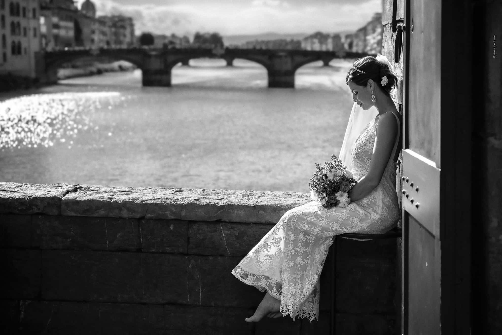 Fine-art black and white portrait of an American bride, actress and model, on Ponte Vecchio in Florence, Tuscany, by luxury wedding photographer Mimmo De Nicolais.