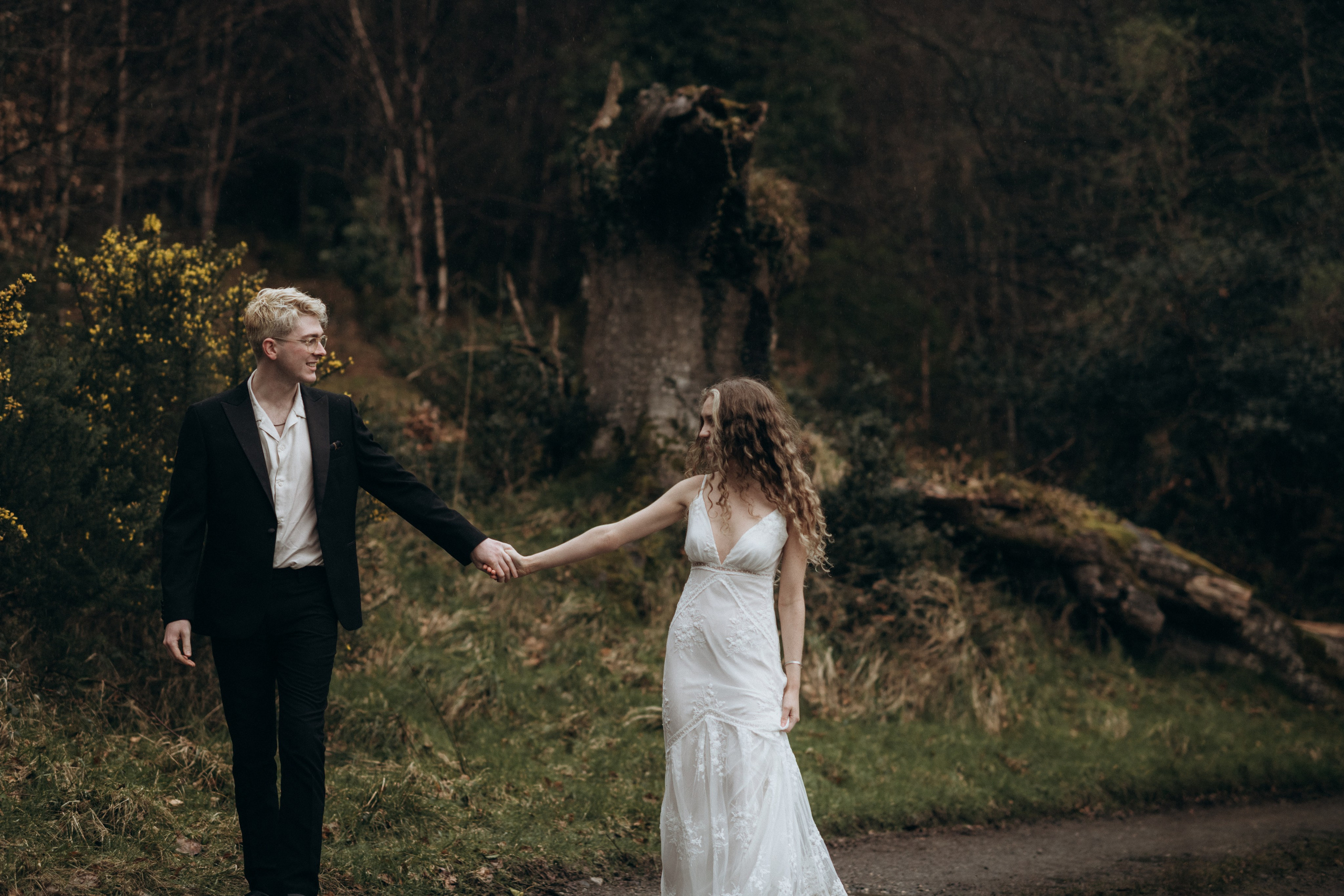 candid photograph of young couple in the woods
