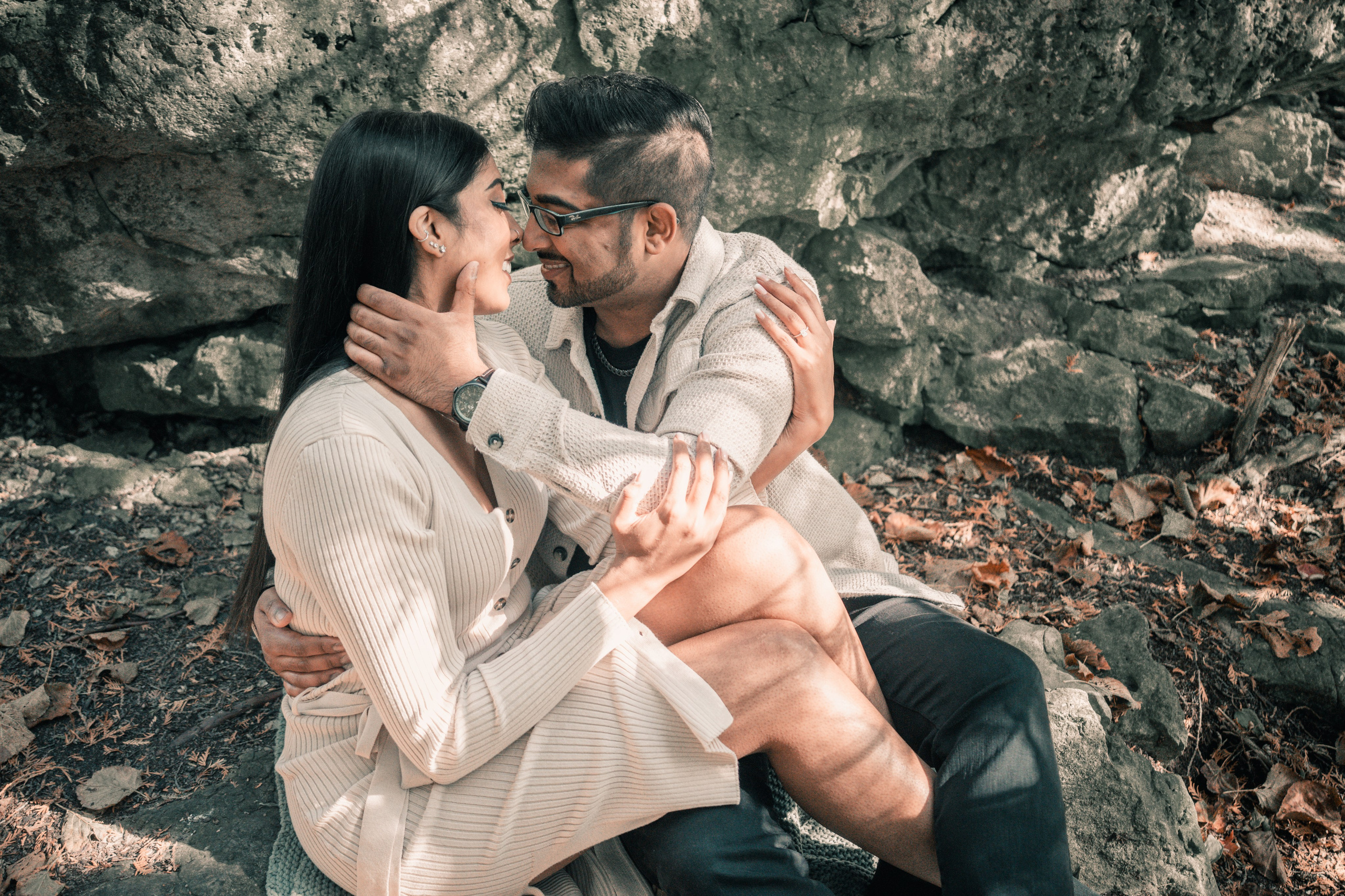 Couple walking through a golden autumn park, capturing their engagement moments
