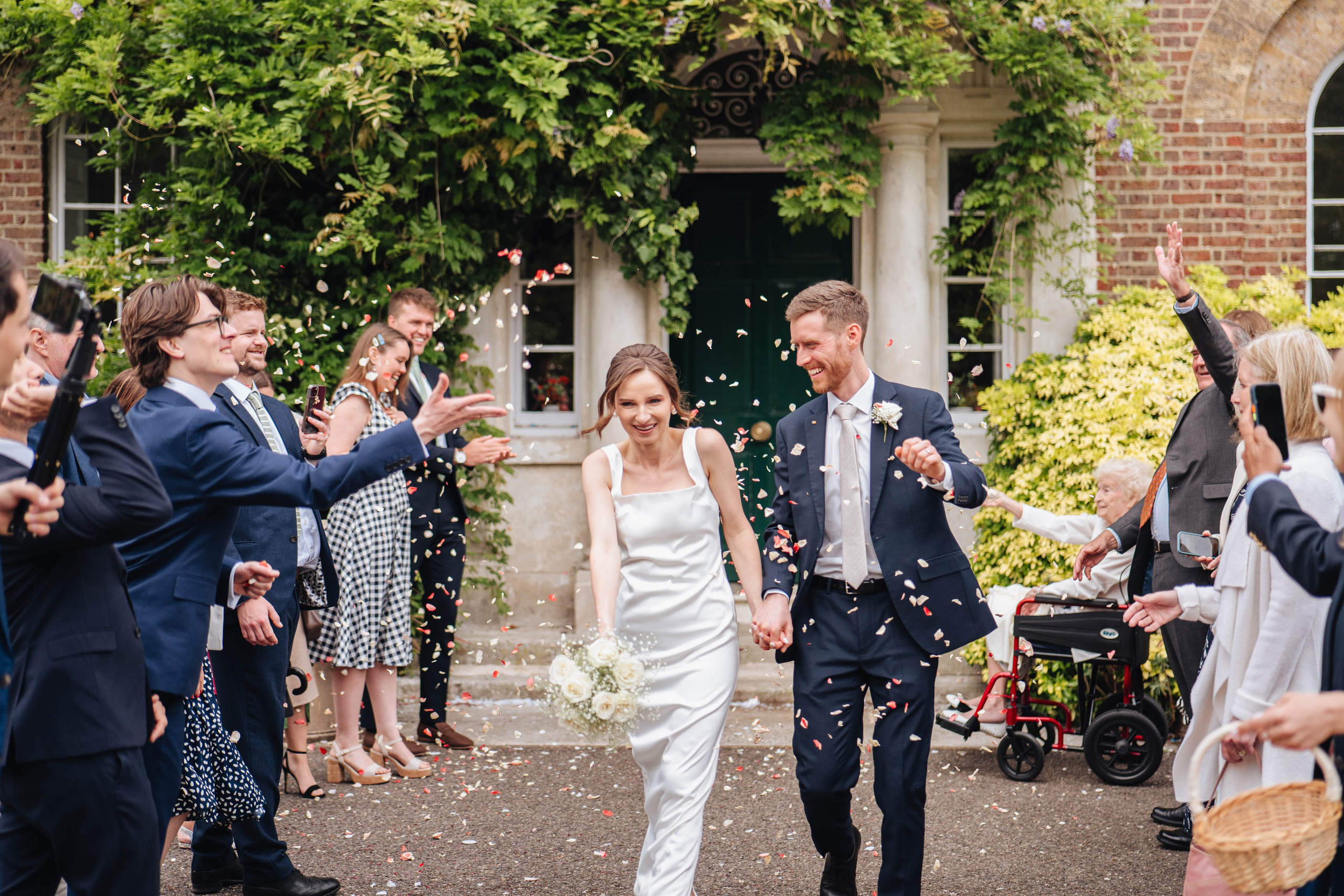 bride and groom happy to see confetti after the ceremony 