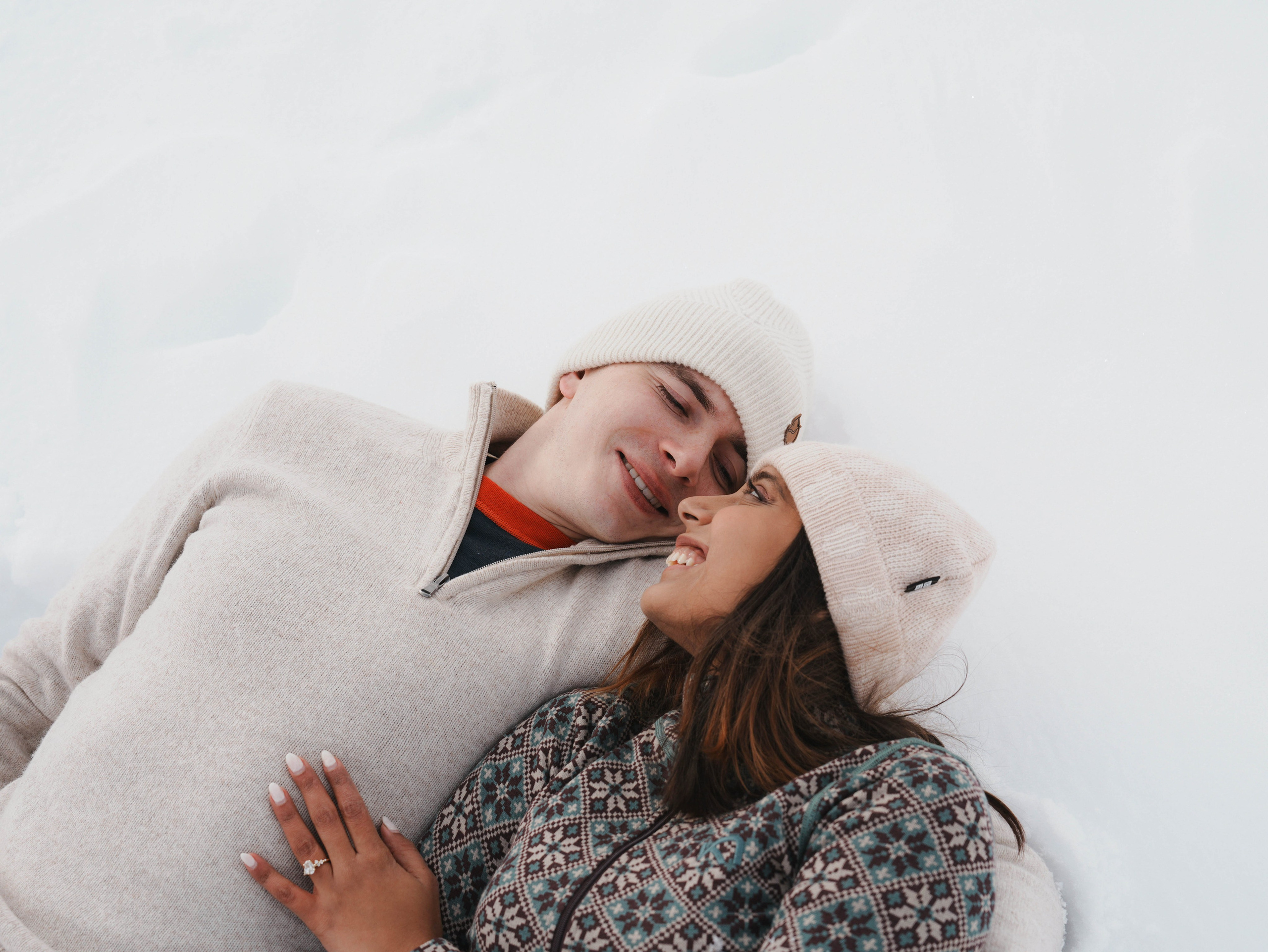 Close up couple hugging in snow mountains