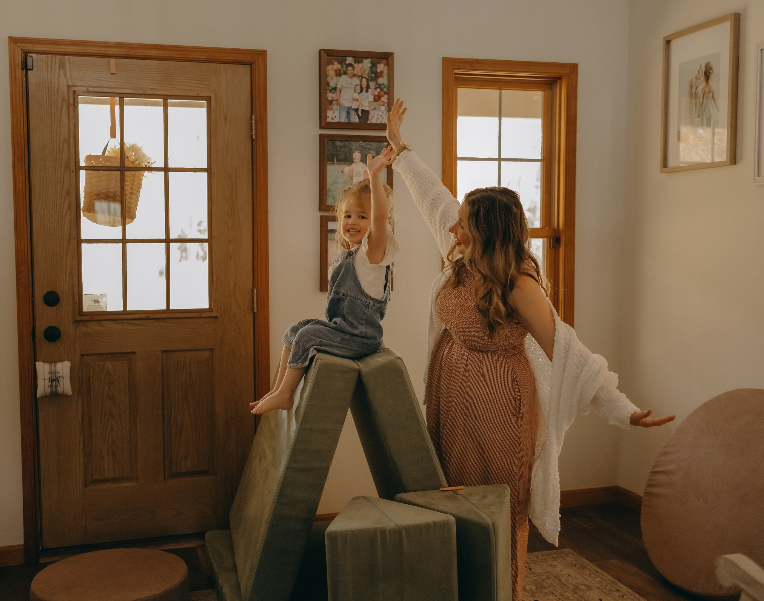 Mom and her little daughter playing and pretending the airplane during the family motherhood photo session in Philadelphia 