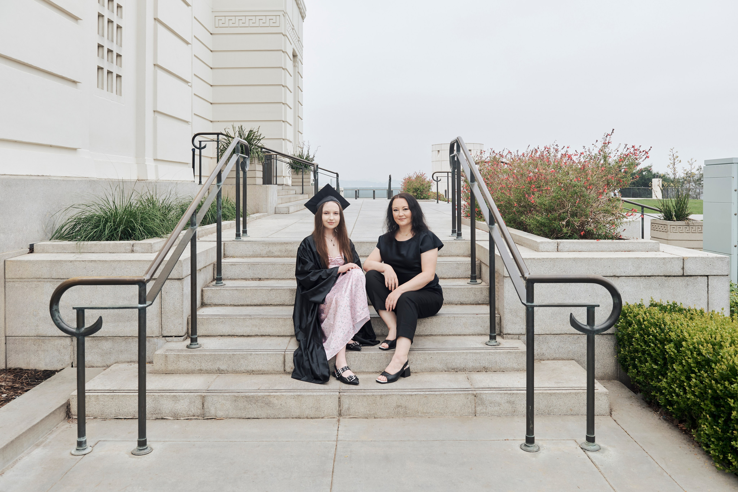 Graduate and friends enjoying a festive moment at a Los Angeles park