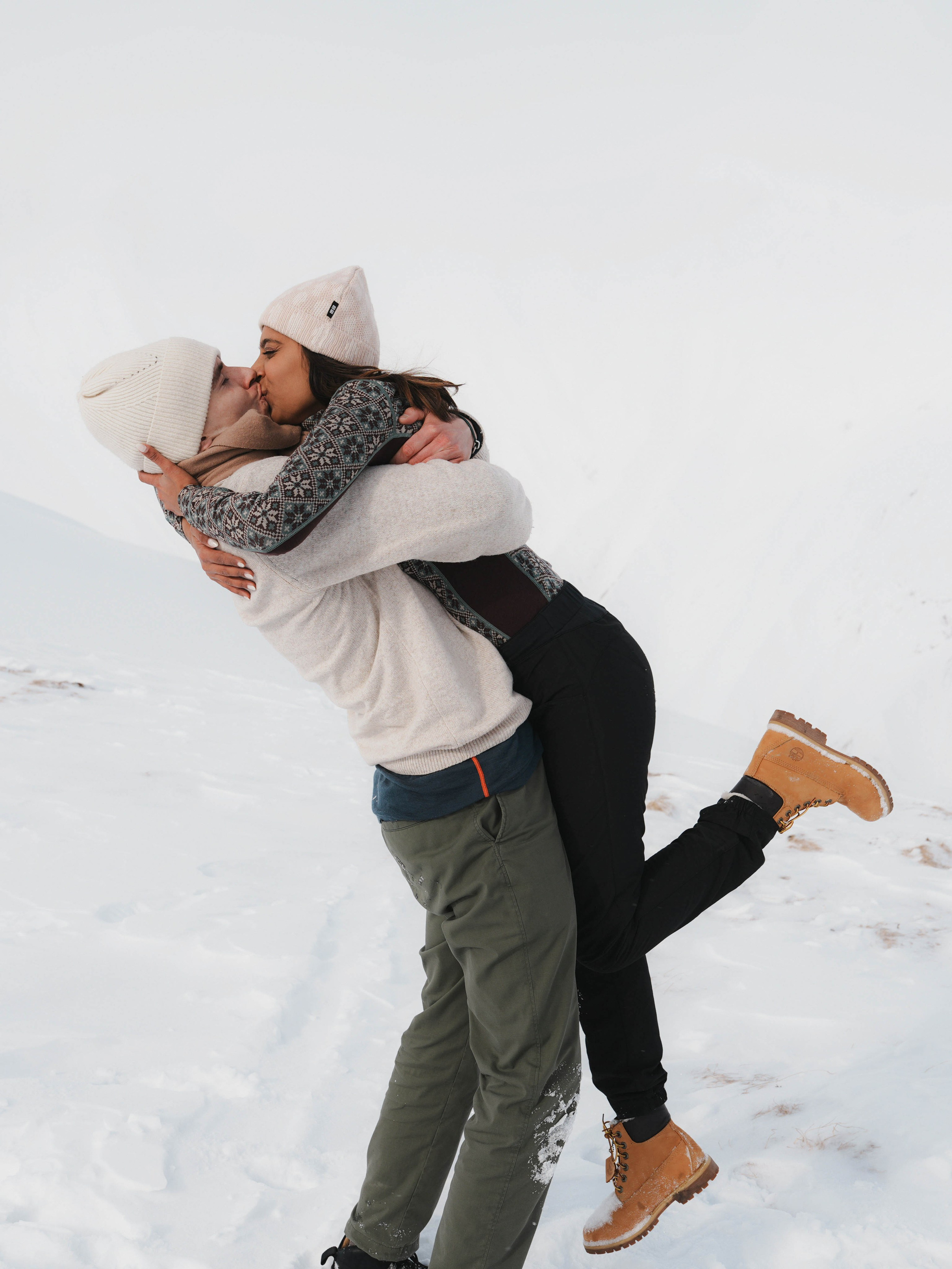 Man lifting woman in snow Gudauri winter photoshoot