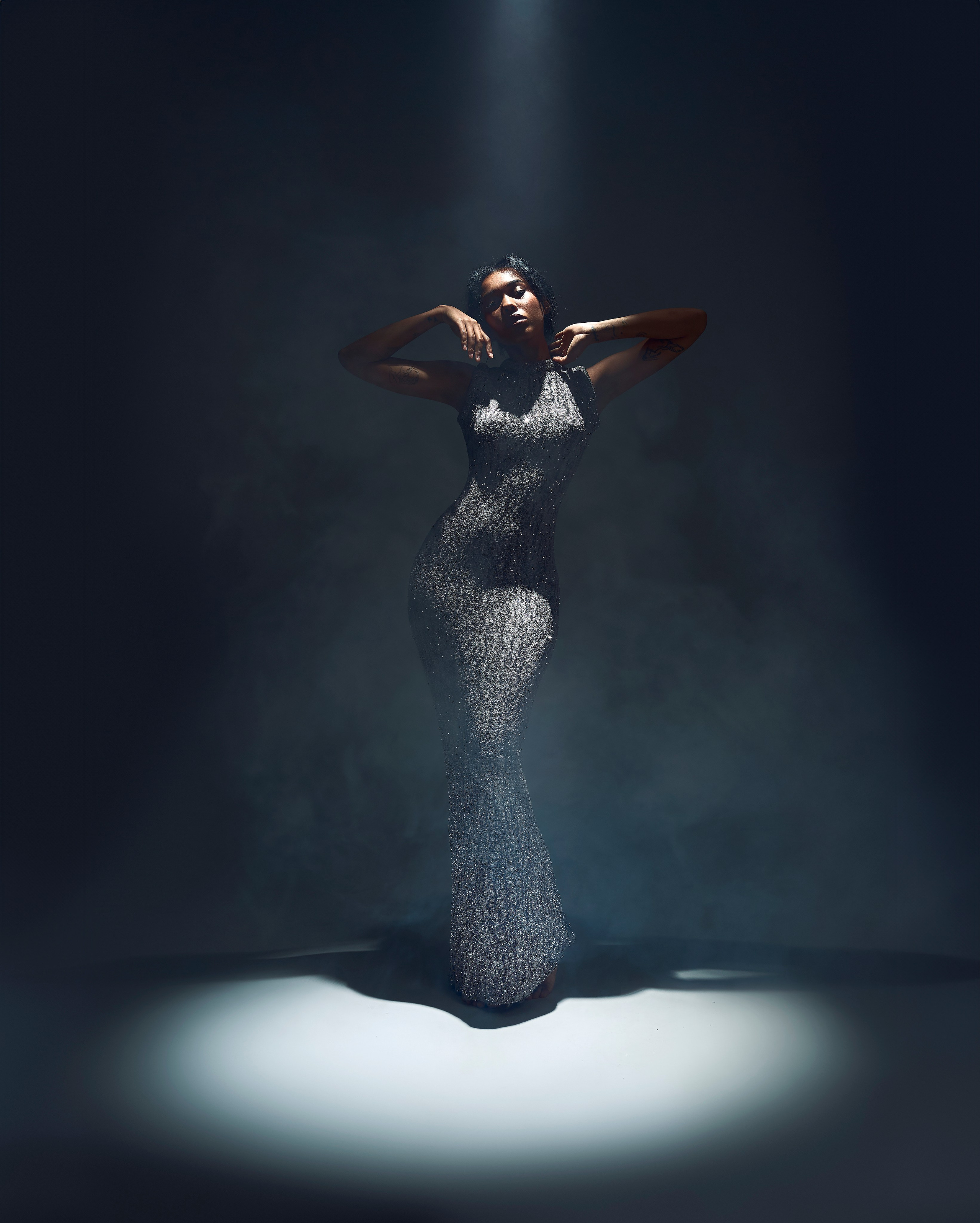 Dramatic fashion photography by Hanna Asaulova | Model in graceful evening dress with theatrical lighting, professional studio photoshoot in Vilnius.