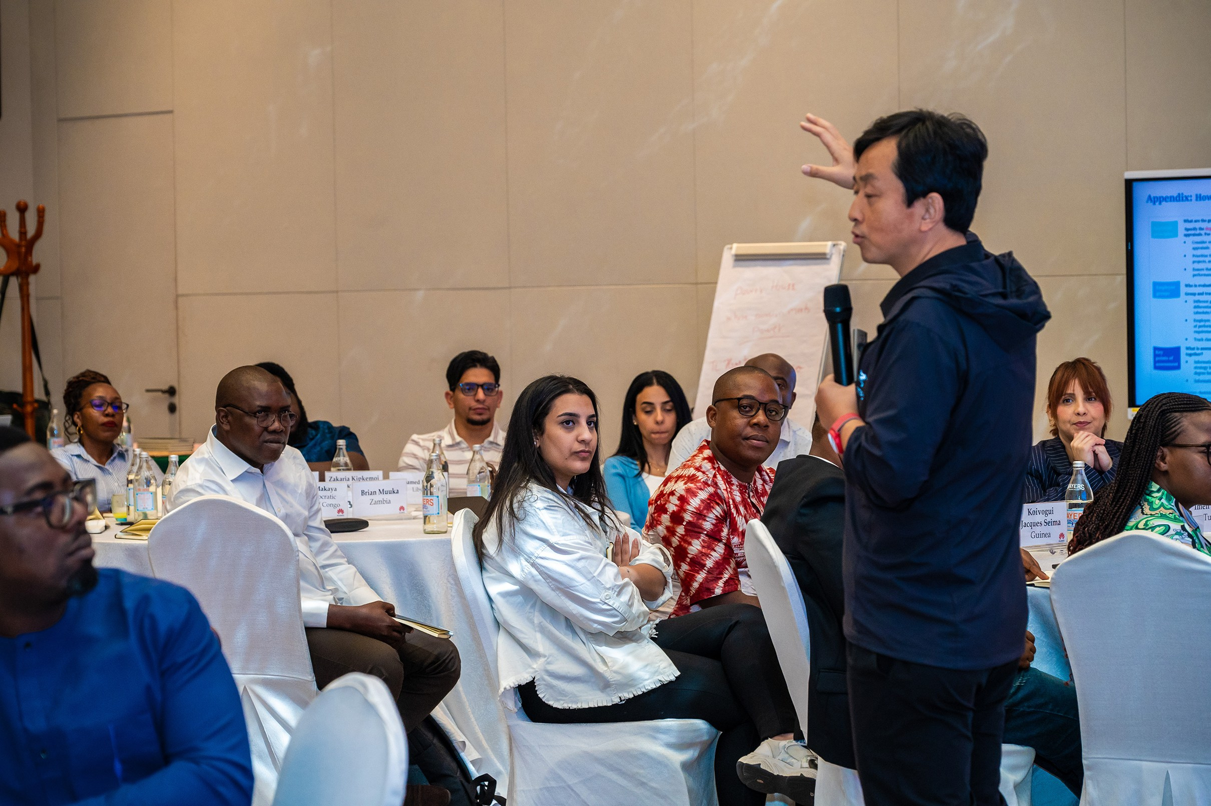 A medium shot of an Event moderator and audience during Huawei's conference in Argyle hotel, Nairobi