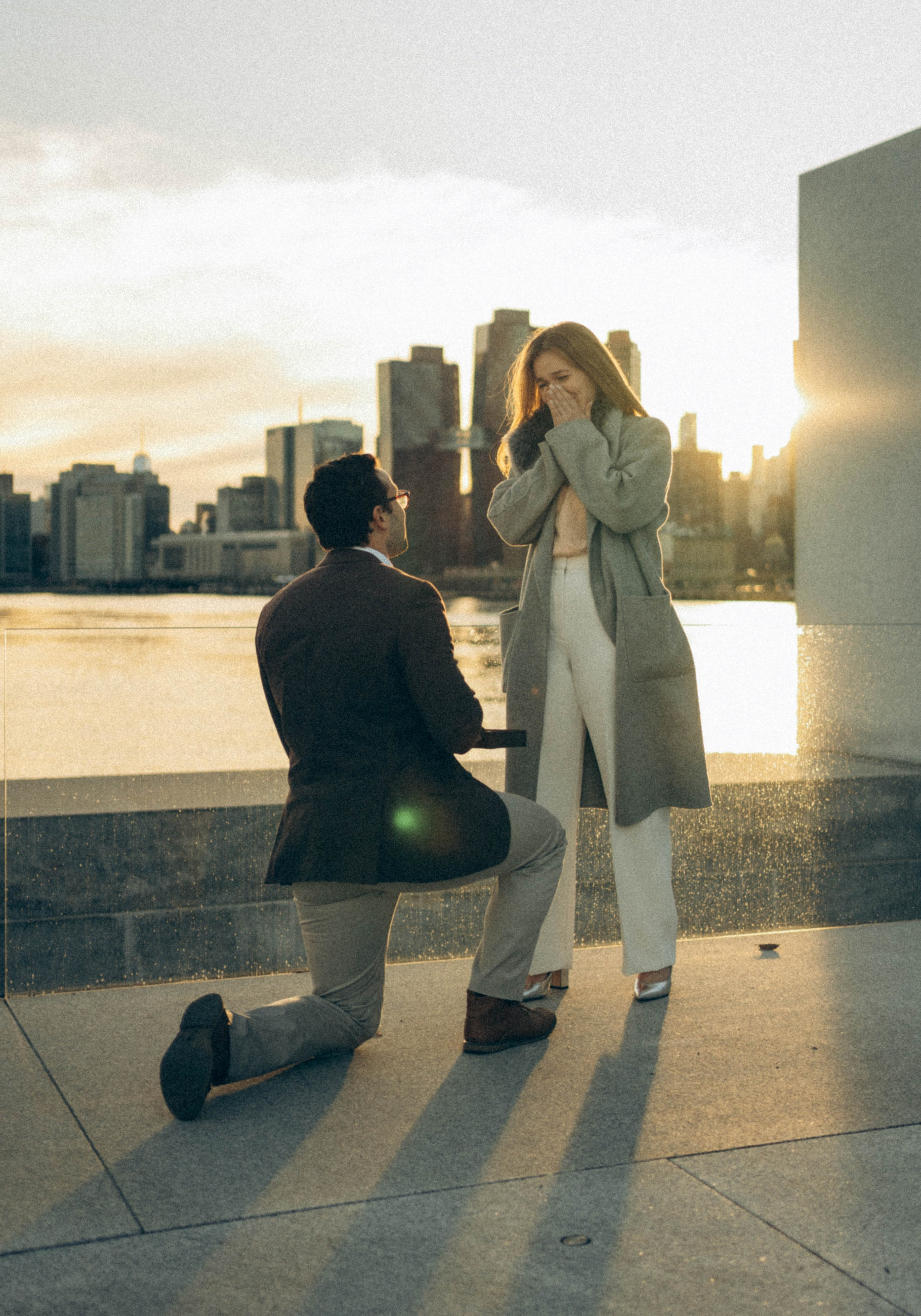Couple kissing after proposal on Brooklyn Bridge tower