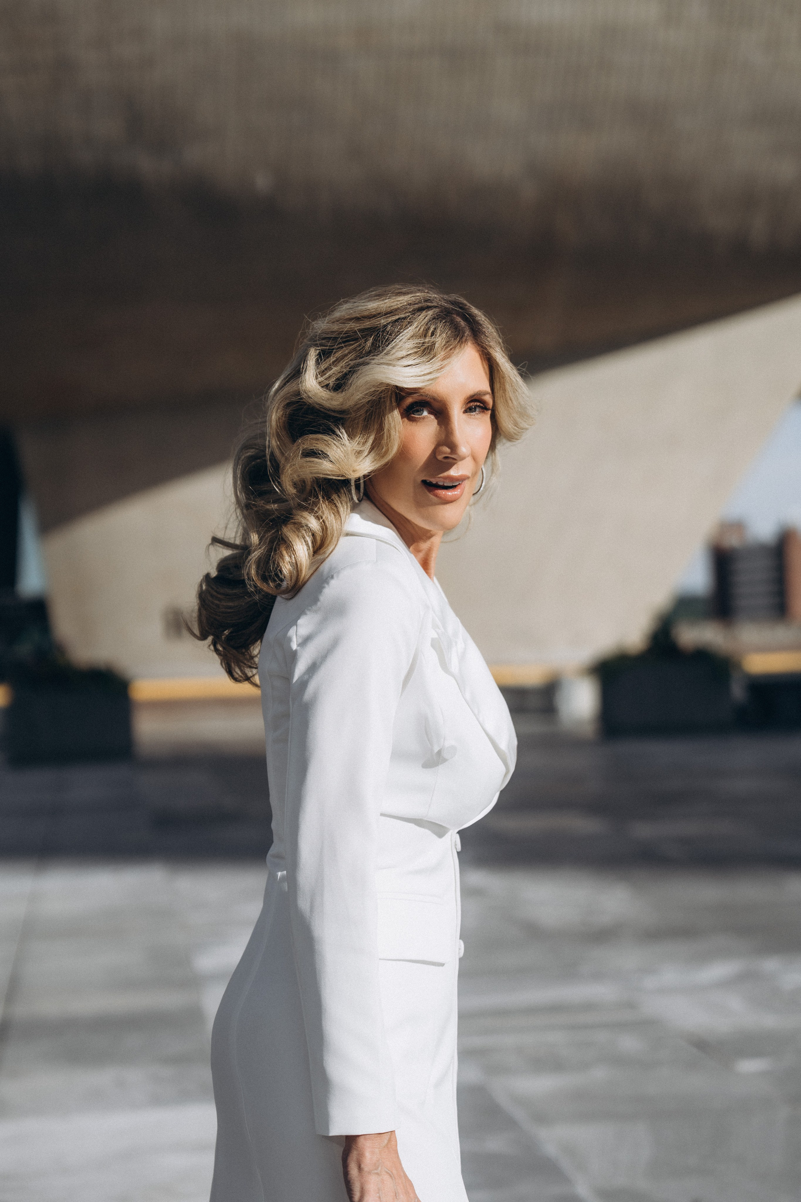 Bride adjusting veil on Lake Placid boathouse dock.