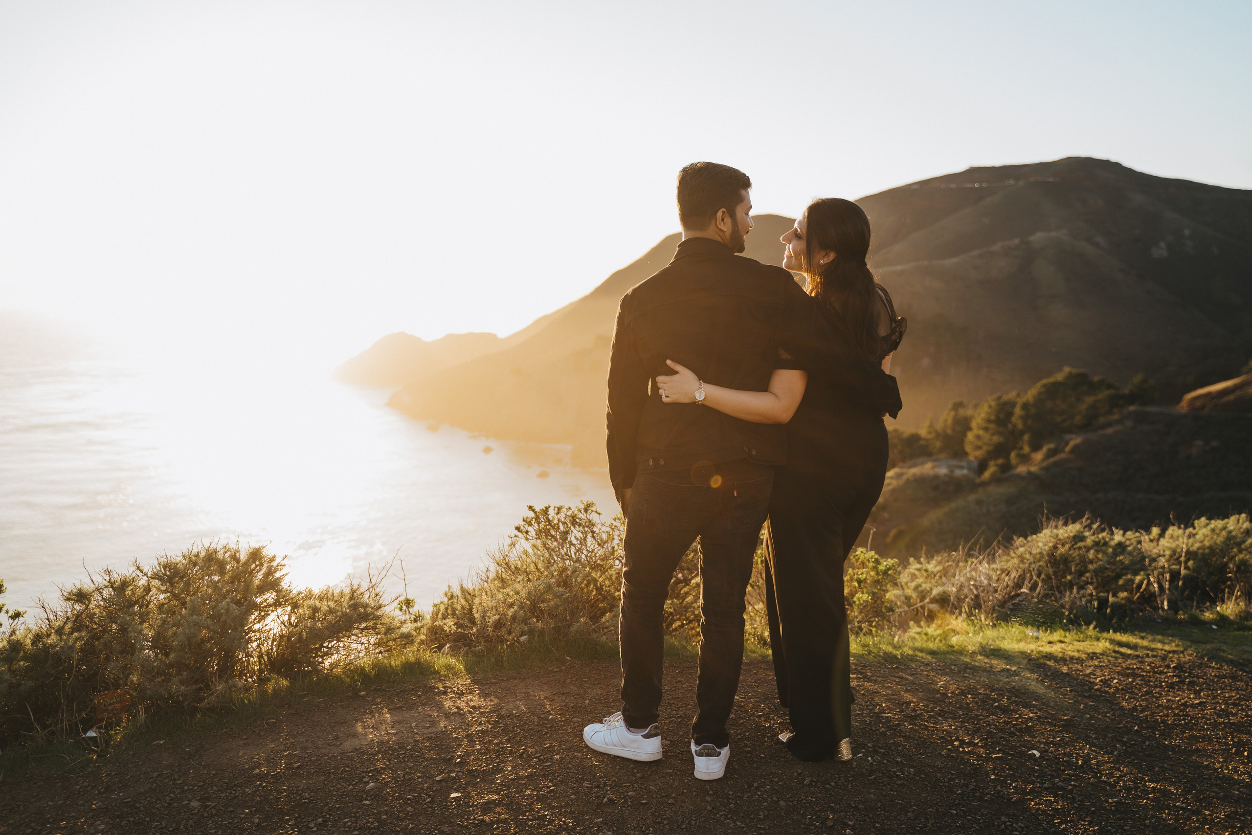 Proposal.  Overlooking the golden San Franisco Bridge sunset with a couple. Photographer Video. 