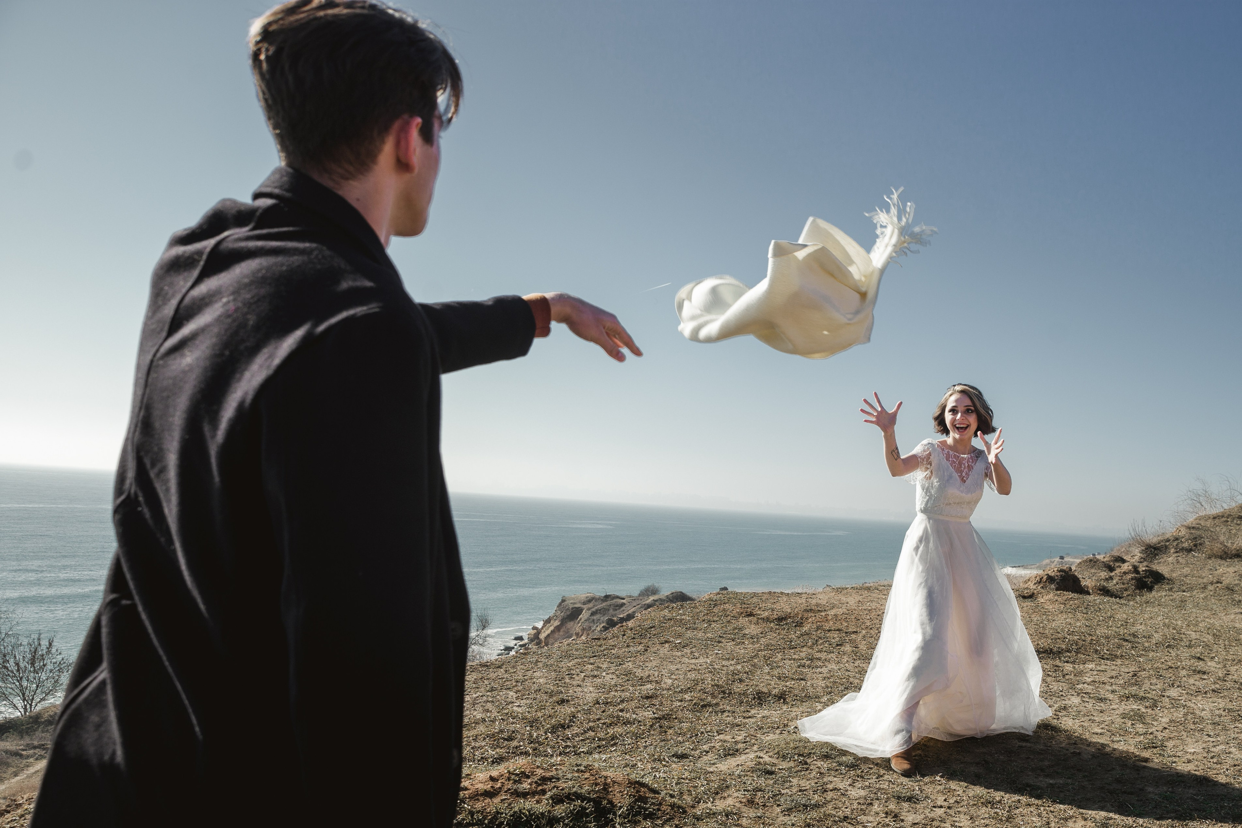 Bride and groom walking barefoot on the sand, wedding photographer Spain