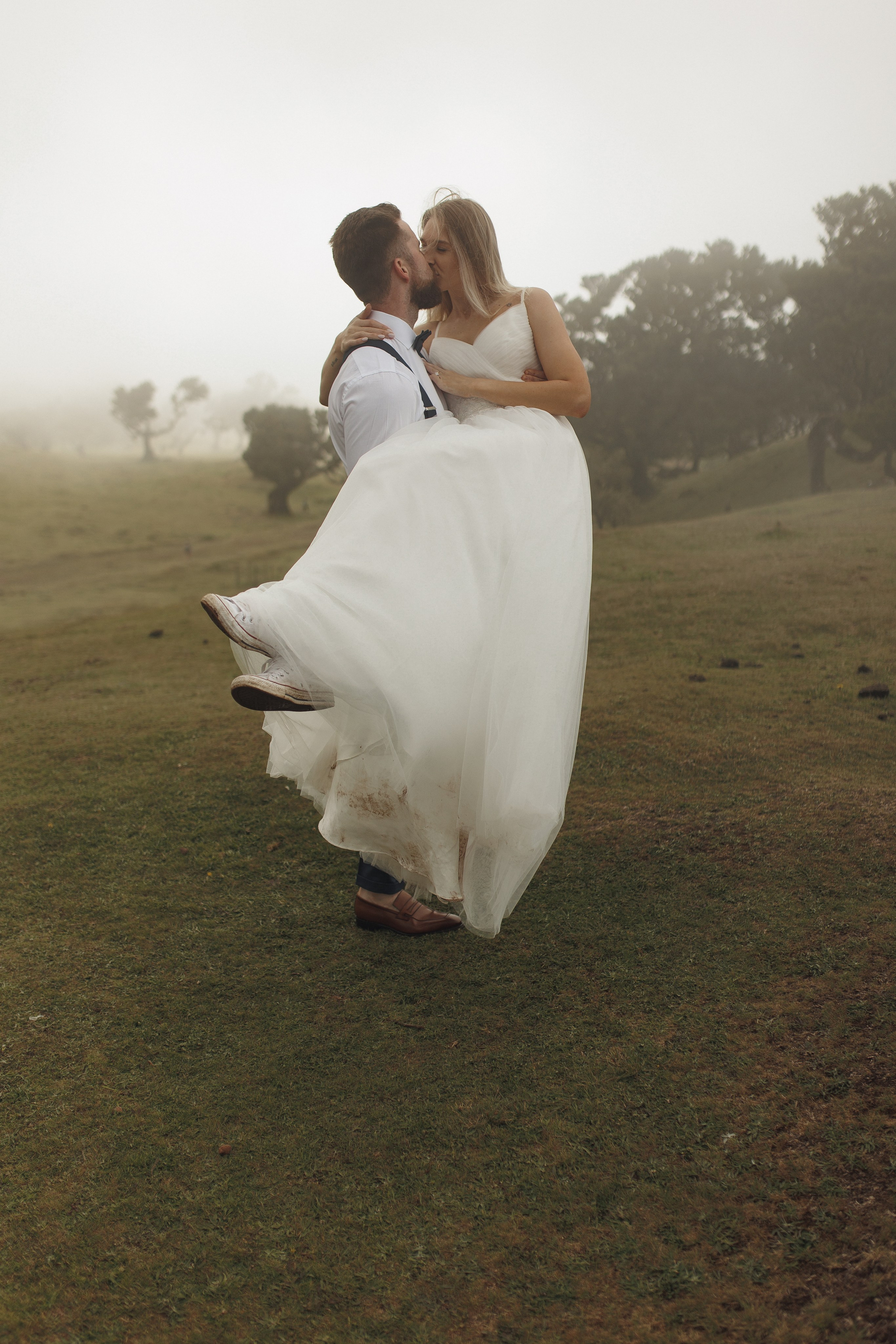 Bride and groom share a kiss in the Fanal Forest during their Madeira elopement