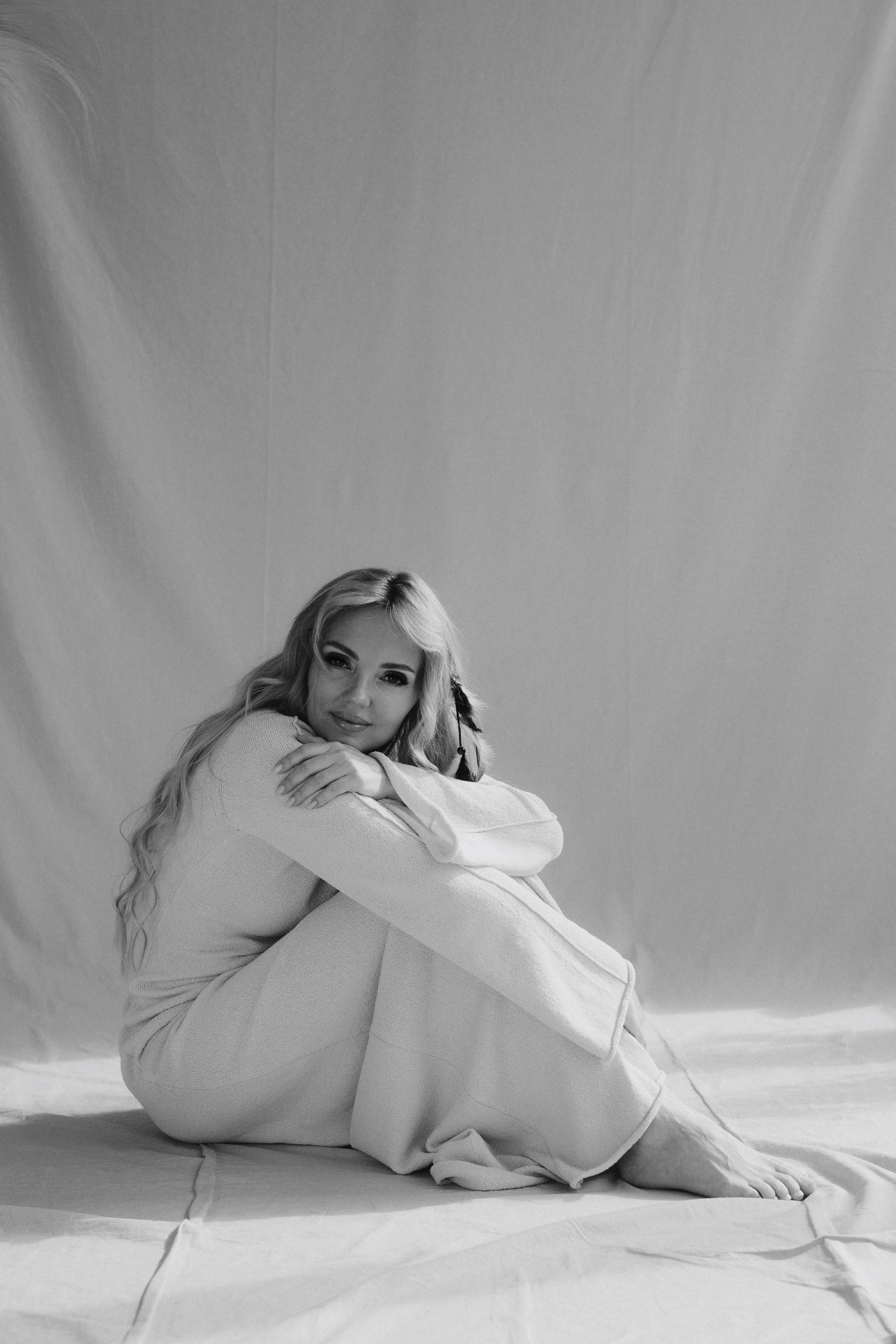 Seated fine art portrait in monochrome tones with soft shadows and minimalist composition. Художественный сидячий портрет в монохромных оттенках с мягкими тенями и минималистичной композицией.