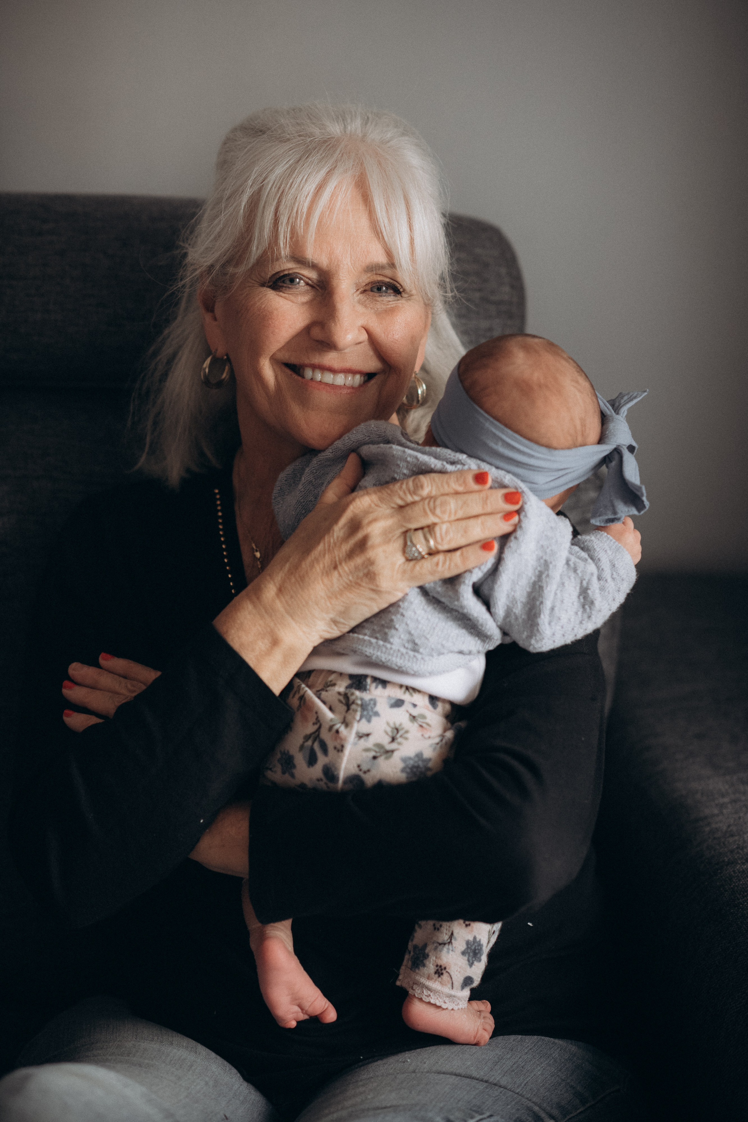 grandmother kissing newborn baby