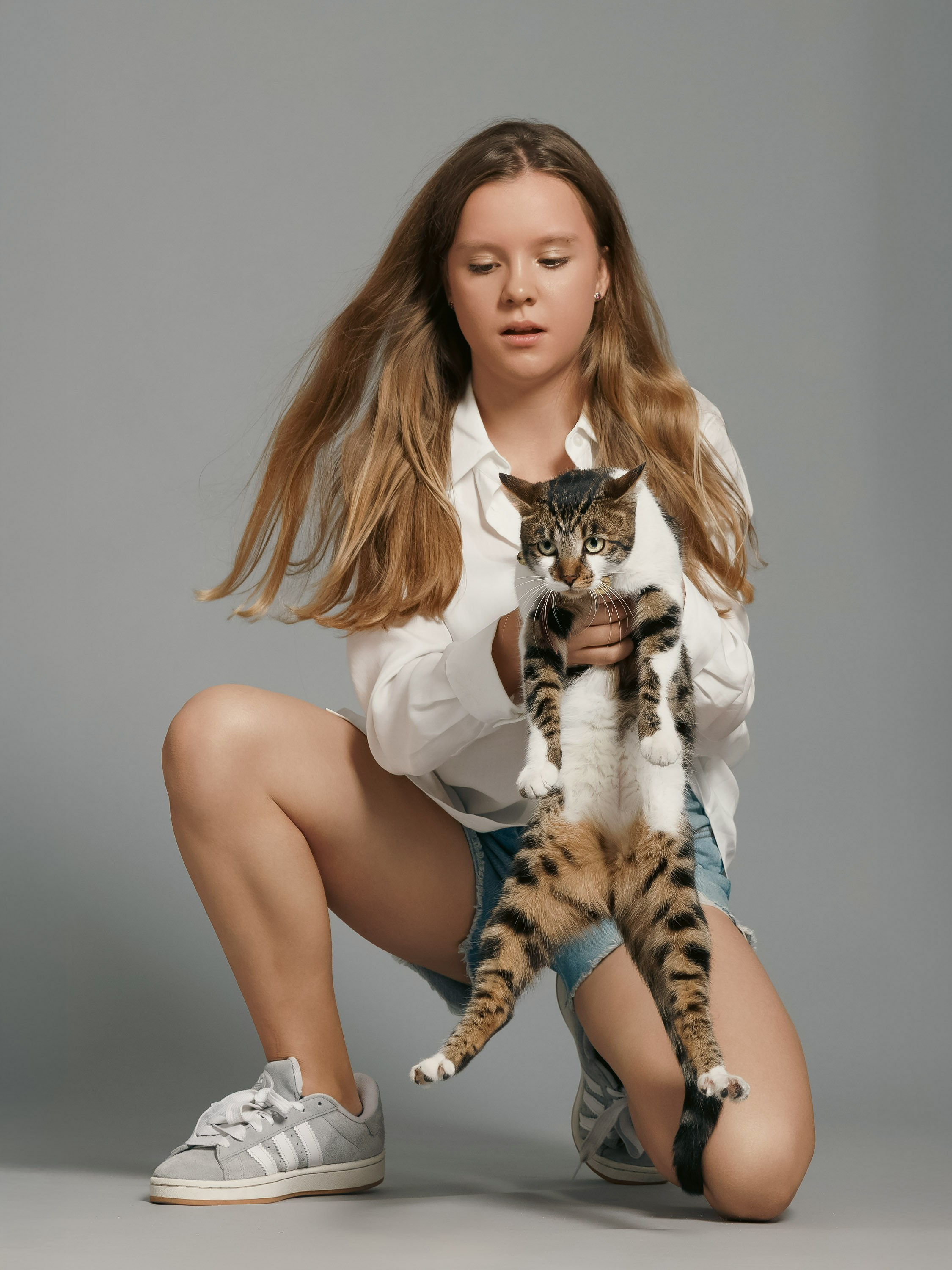 girl holding a cat, studio portrait, London
