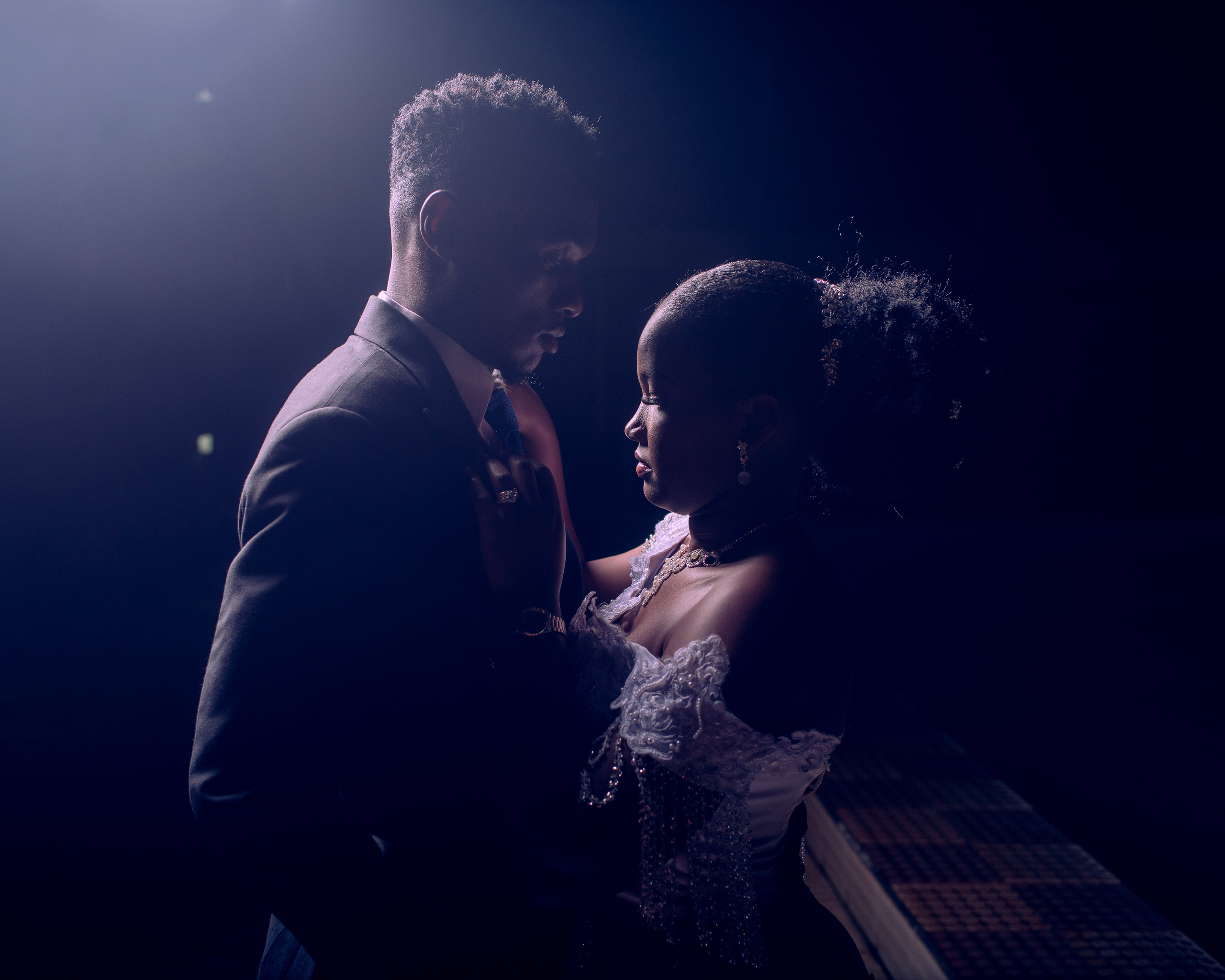 A cinematic portrait of a bride and groom facing each other, during a wedding photo session in Utalii hotel in Nairobi