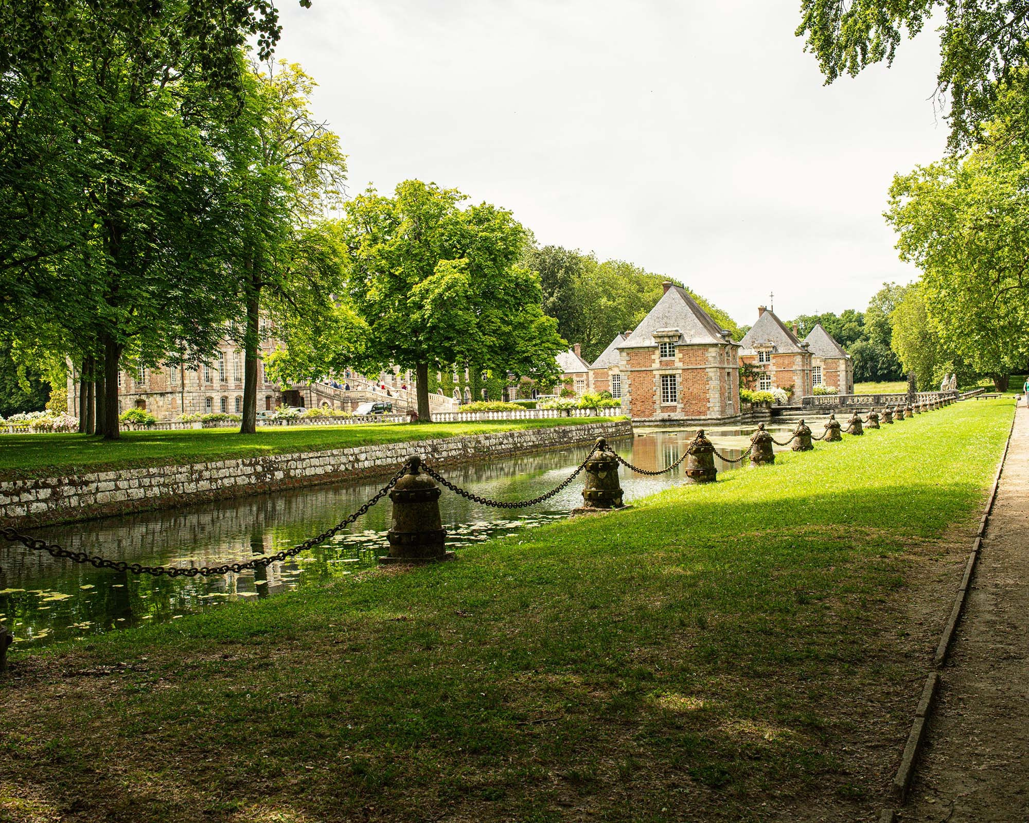 Tree-lined canal and landscaped park at Château de Courances in France