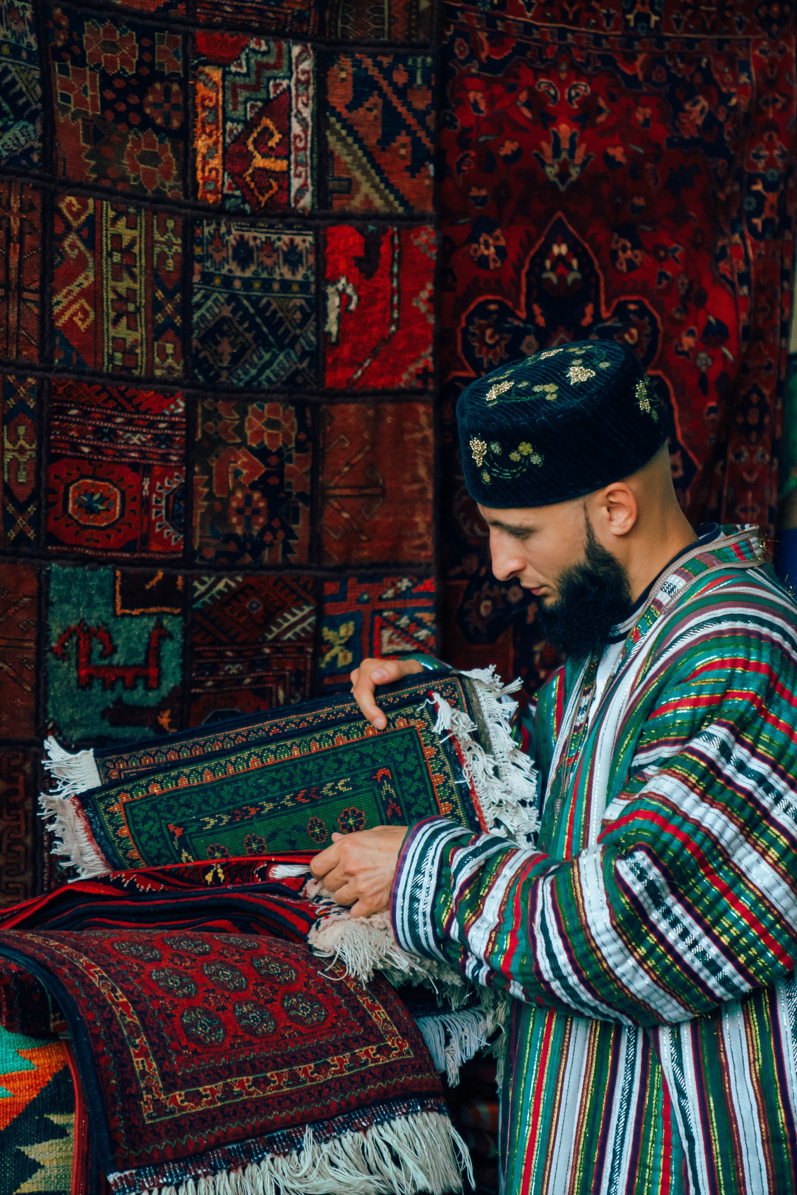 Man in national attire against the backdrop of ancient walls of Bukhara