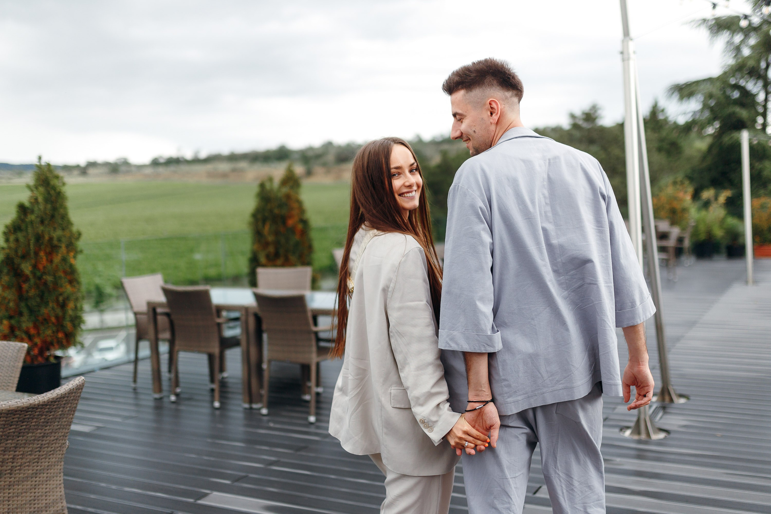 Couple walking together outdoors, relaxed engagement shoot