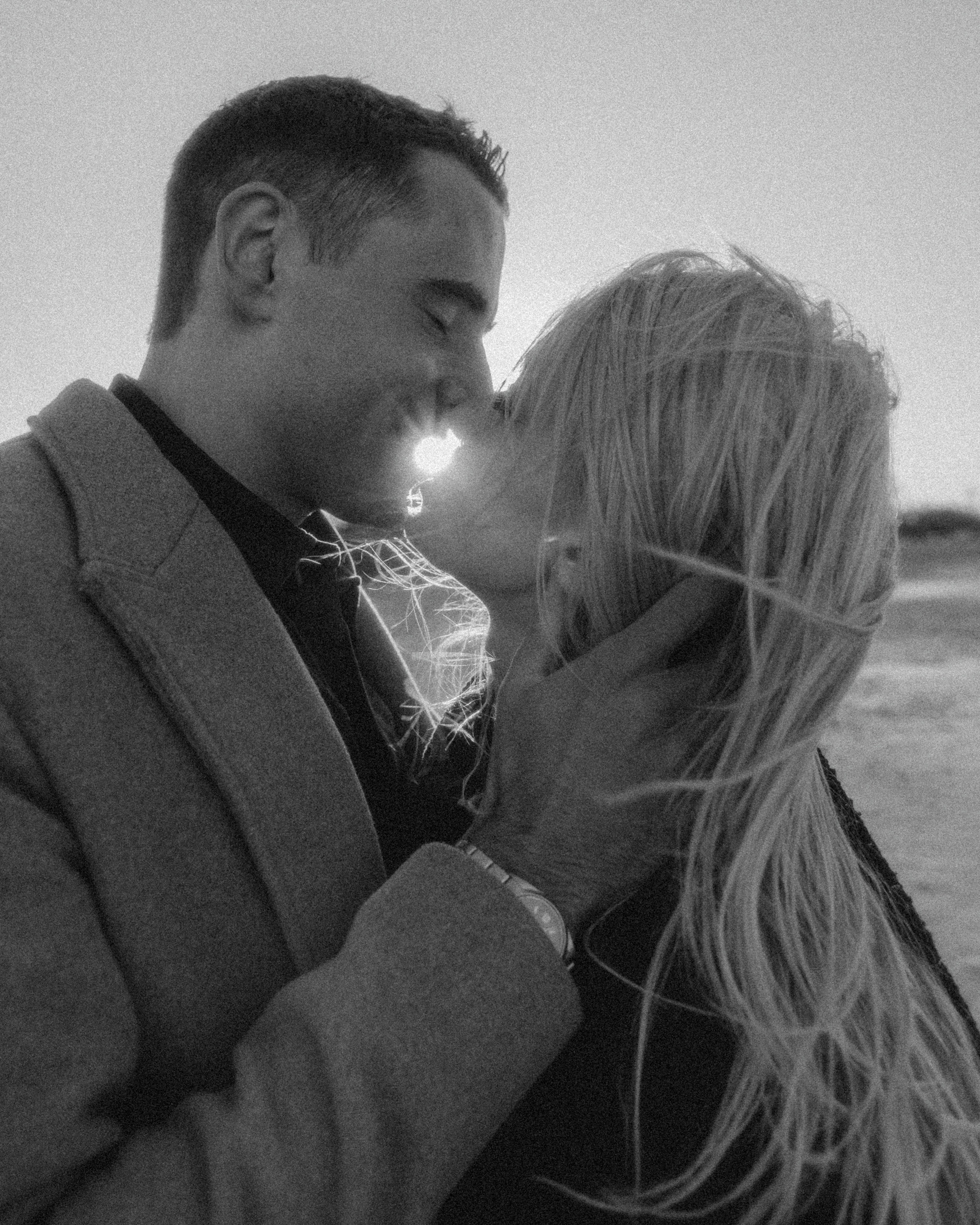 Close-up of intertwined fingers with engagement ring