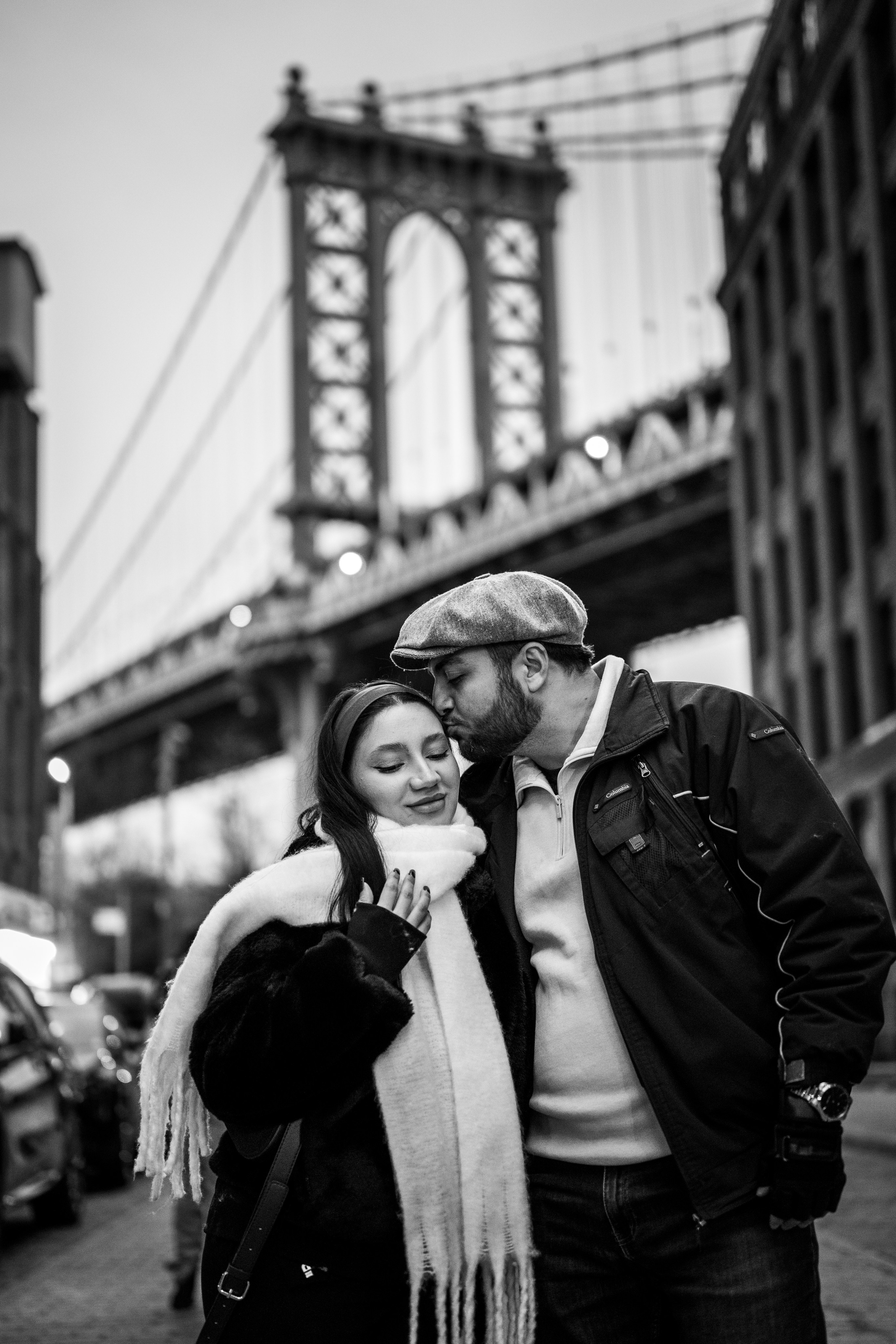 Black and white couple portrait under the Manhattan Bridge in DUMBO, Brooklyn, New York.