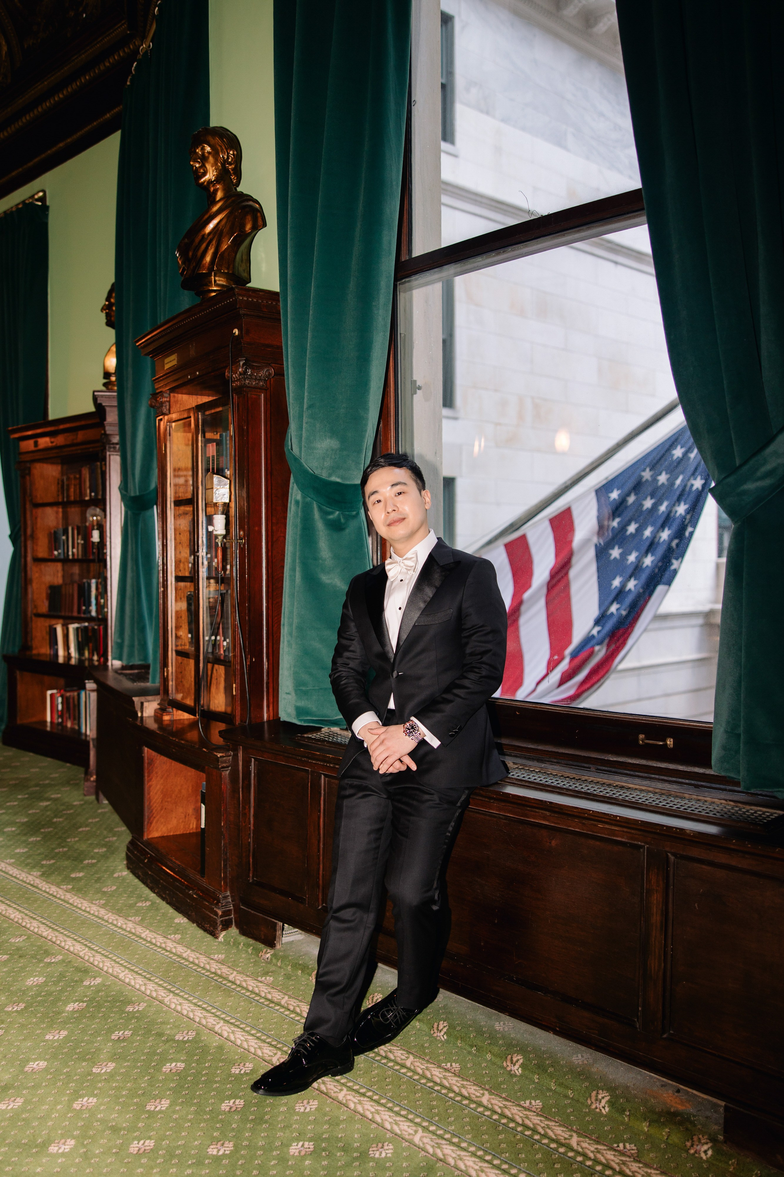 a man in a suit sitting on a chair