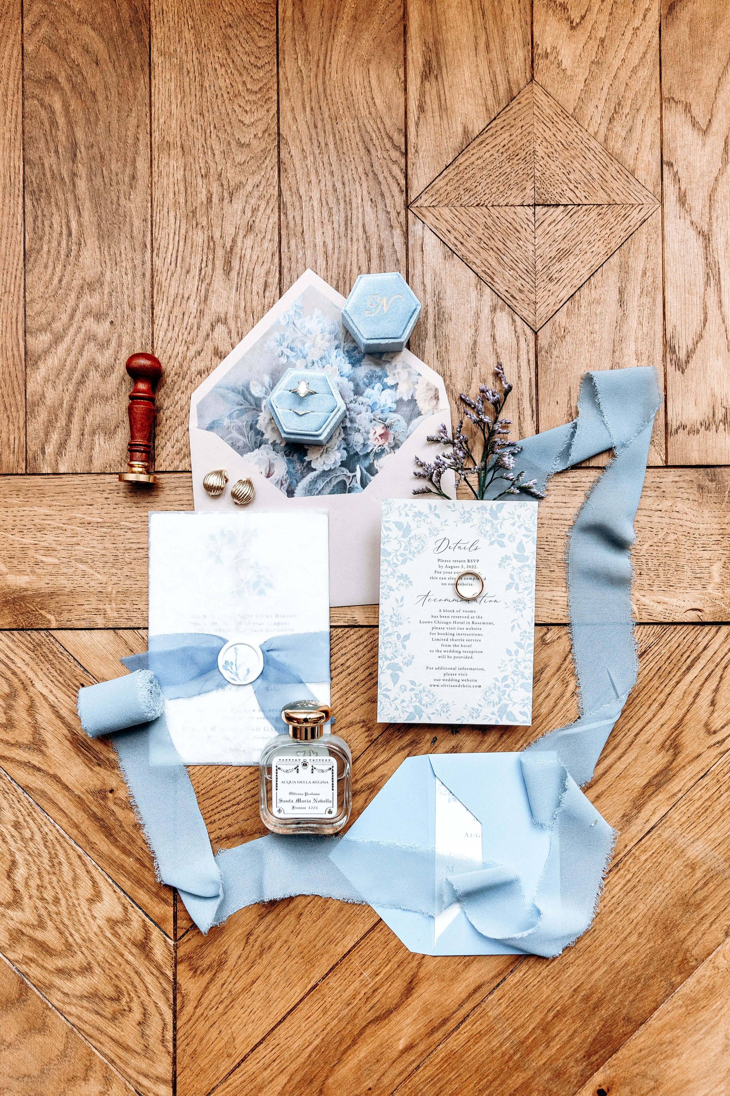Close-up of elegant wedding rings and stationary with intricate designs, captured during a French wedding