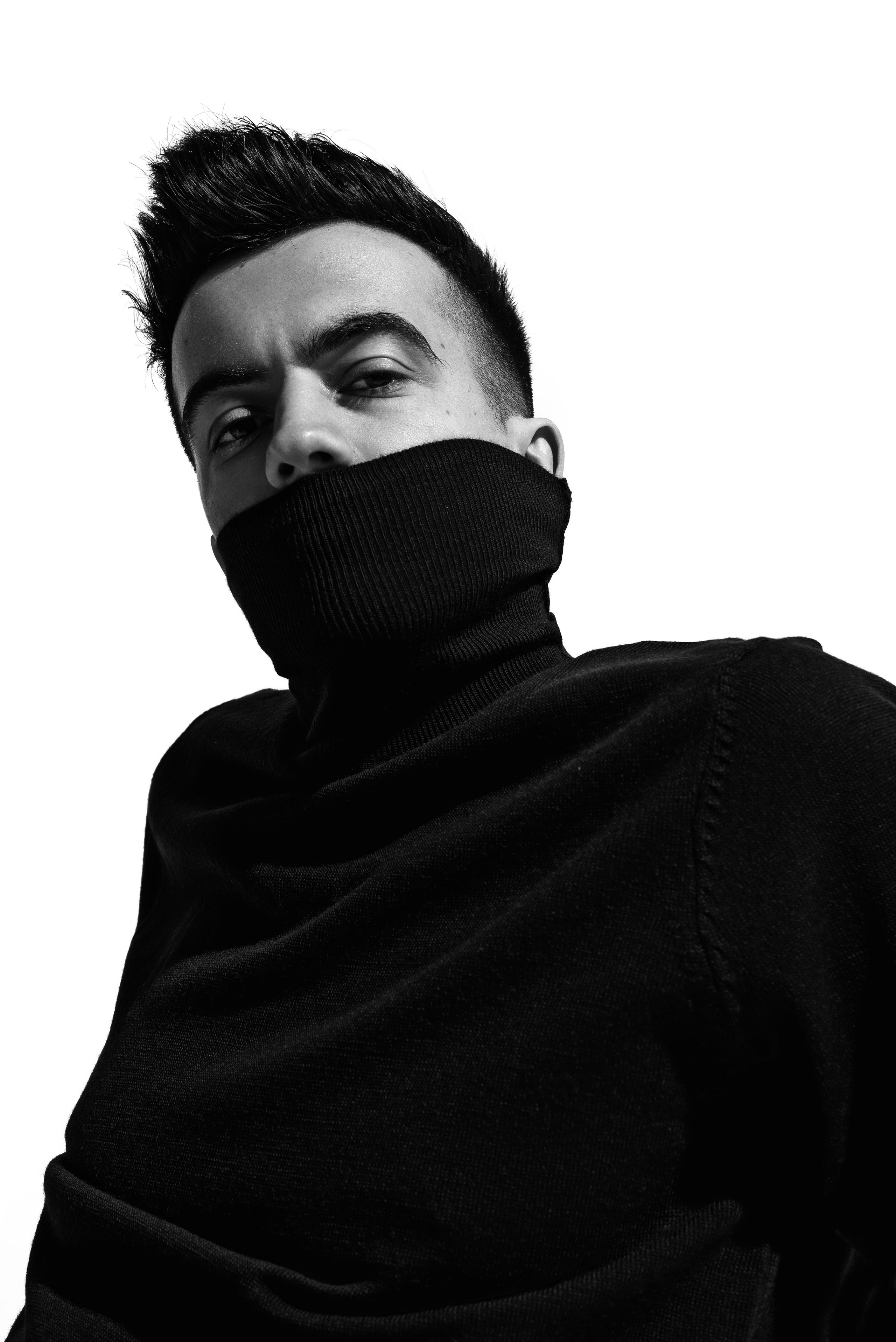 Male model studio portrait with hard lighting, fashion shoot with professional magazine retouching.