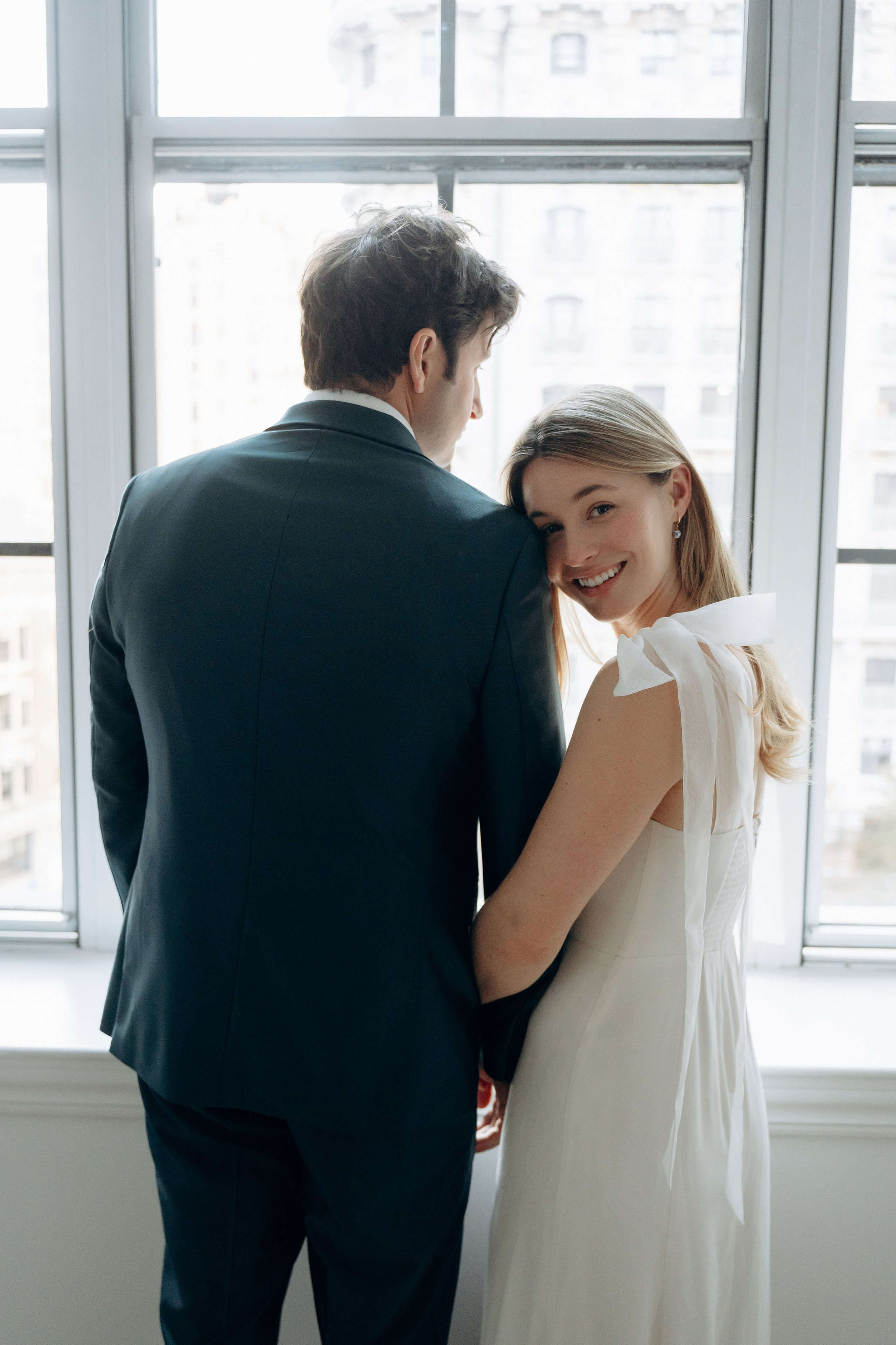 New Jersey wedding photographer capturing bride and groom portraits by the window