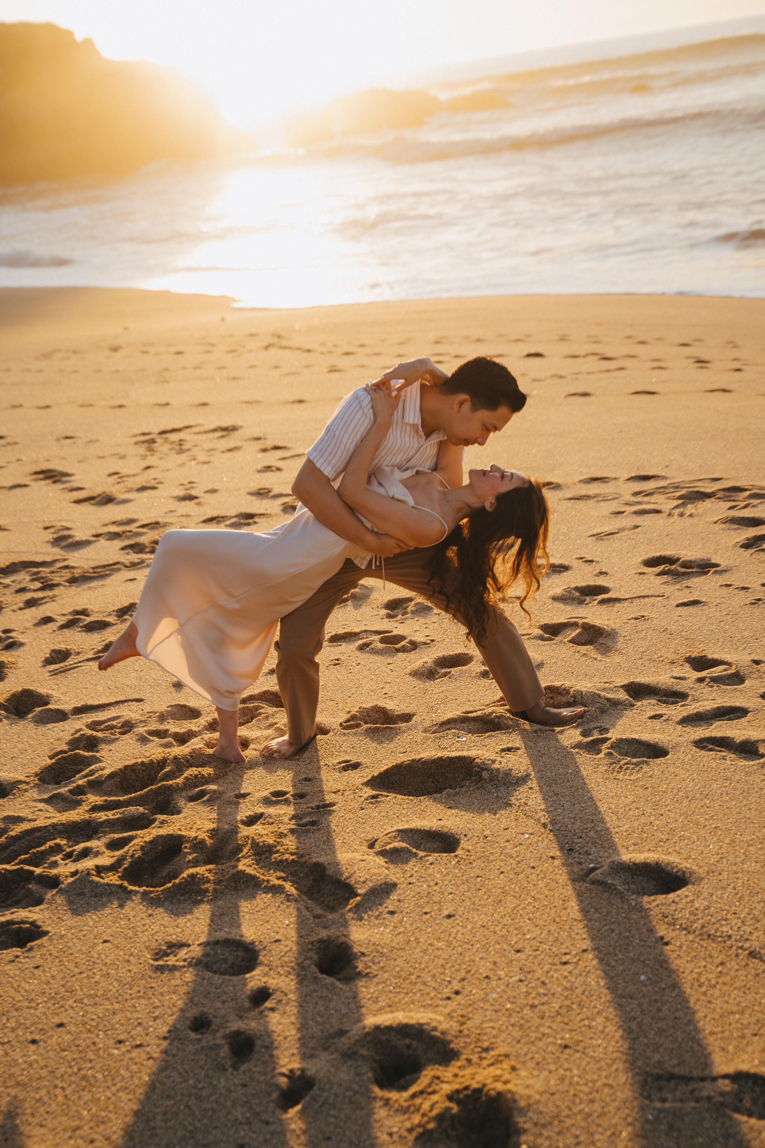A photo shoot on the San Francisco beach at sunset. Engagement session. 
