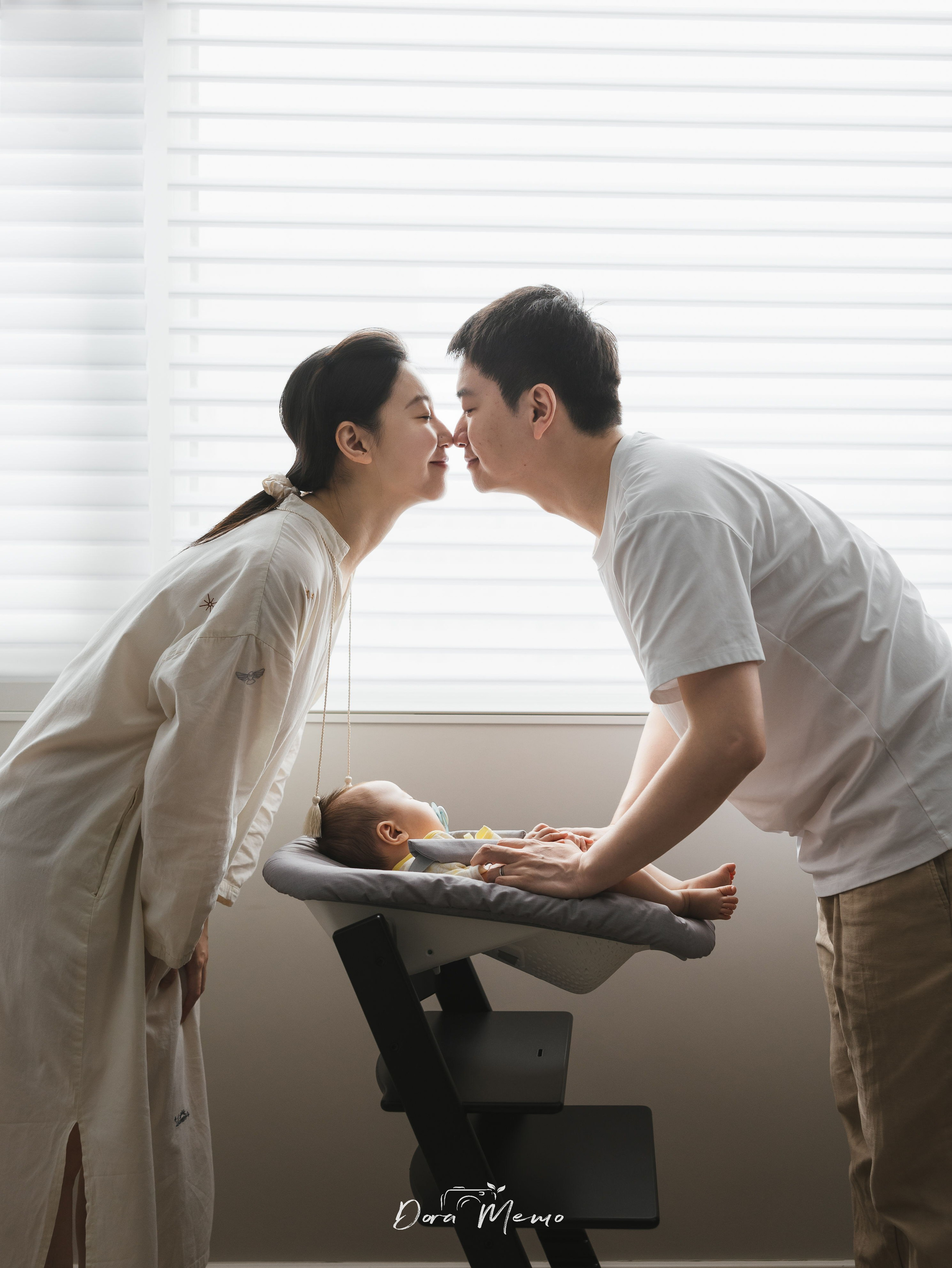 In a family photoshoot, the mother and father look very much in love.