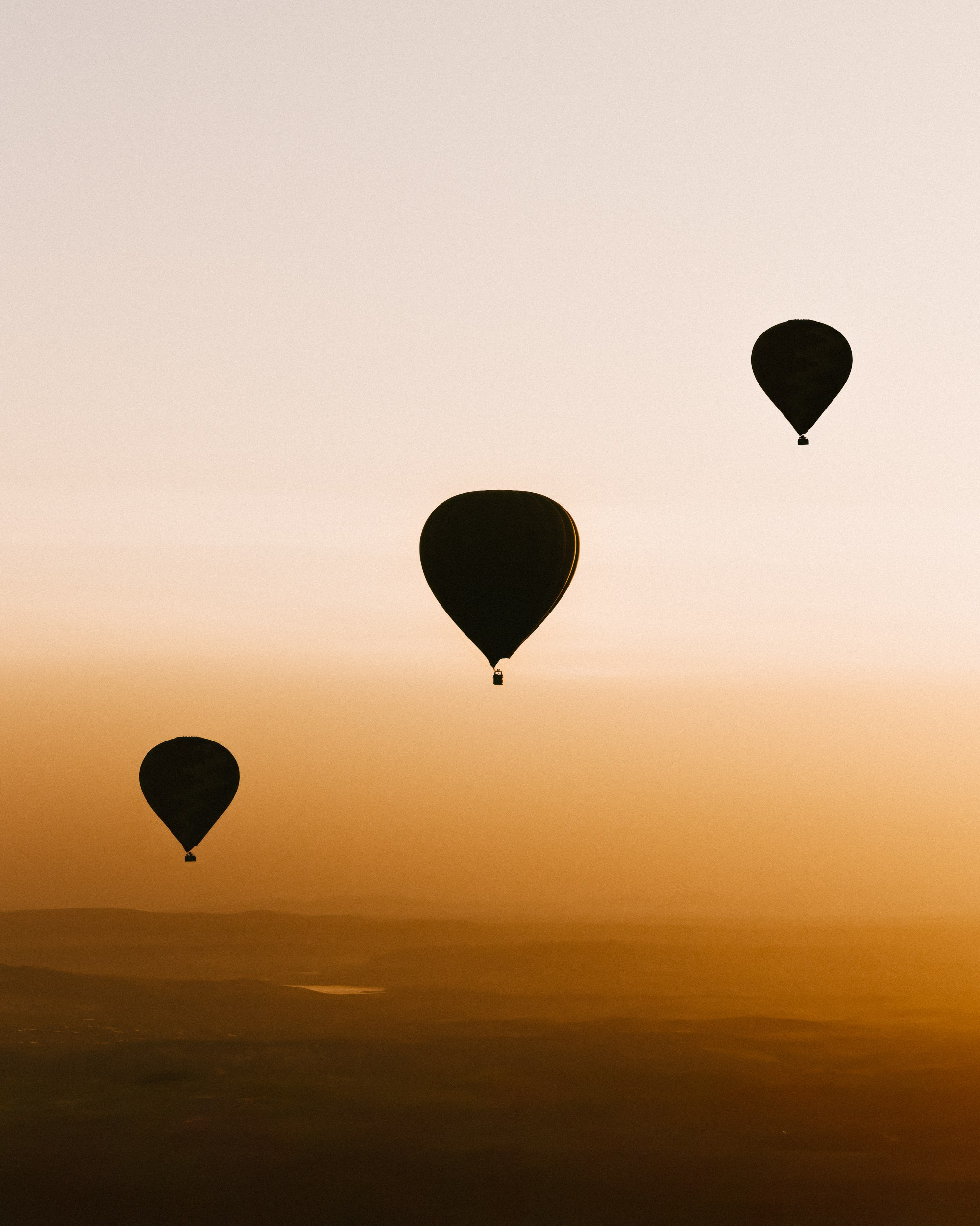 A sunrise photo of three balloons in Cappadocia 
