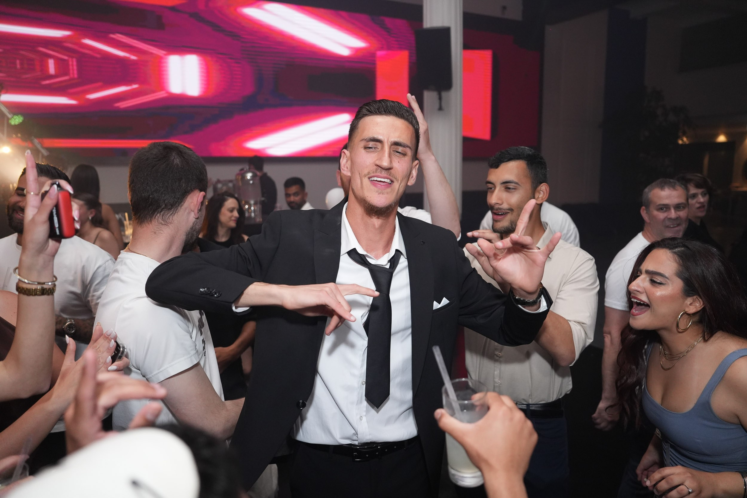 Groom Garik dancing and celebrating with friends during the reception party at Kadita Event Garden in Emek Hefer, Israel