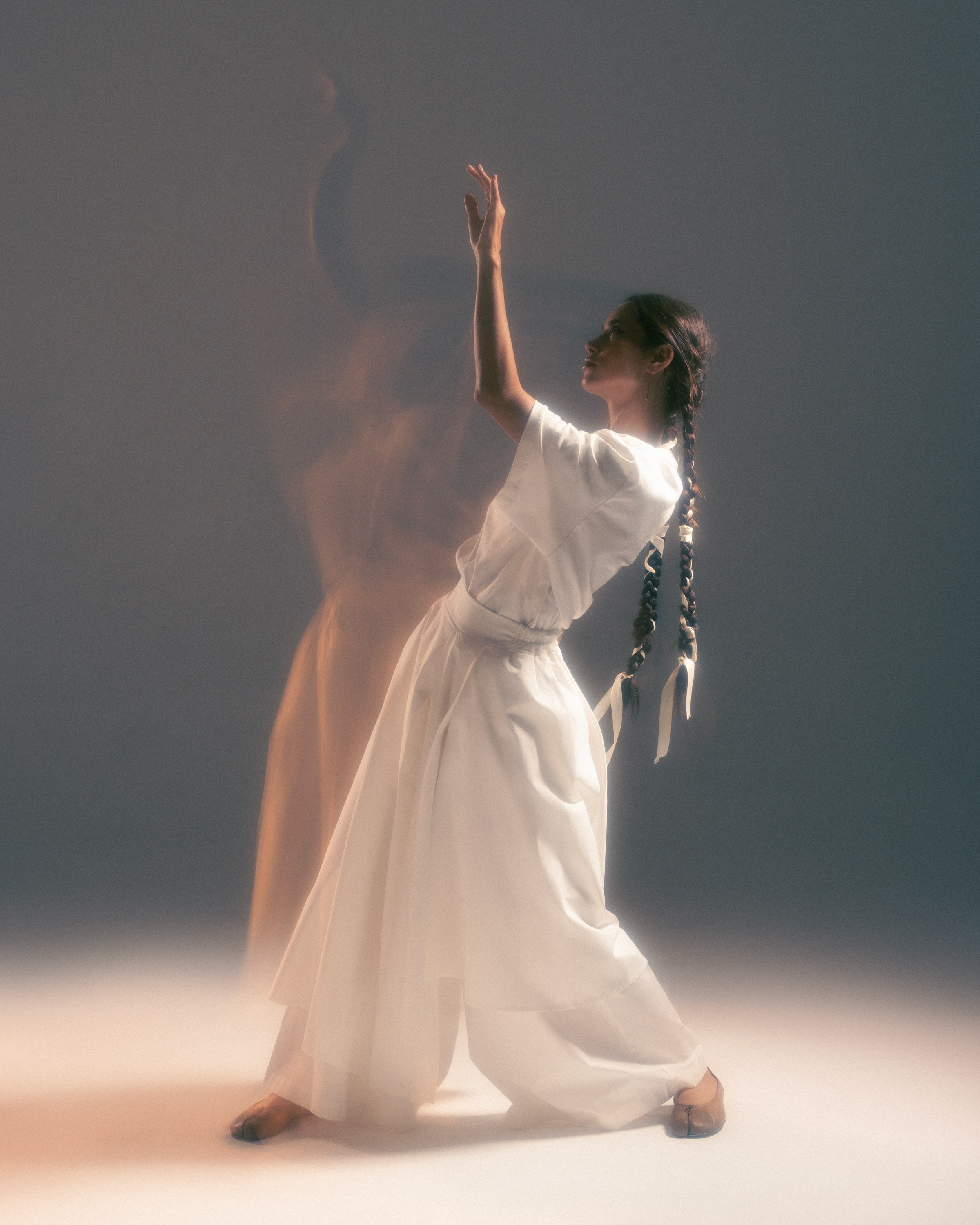 Creative fashion photography featuring a woman in white captured with soft motion trails