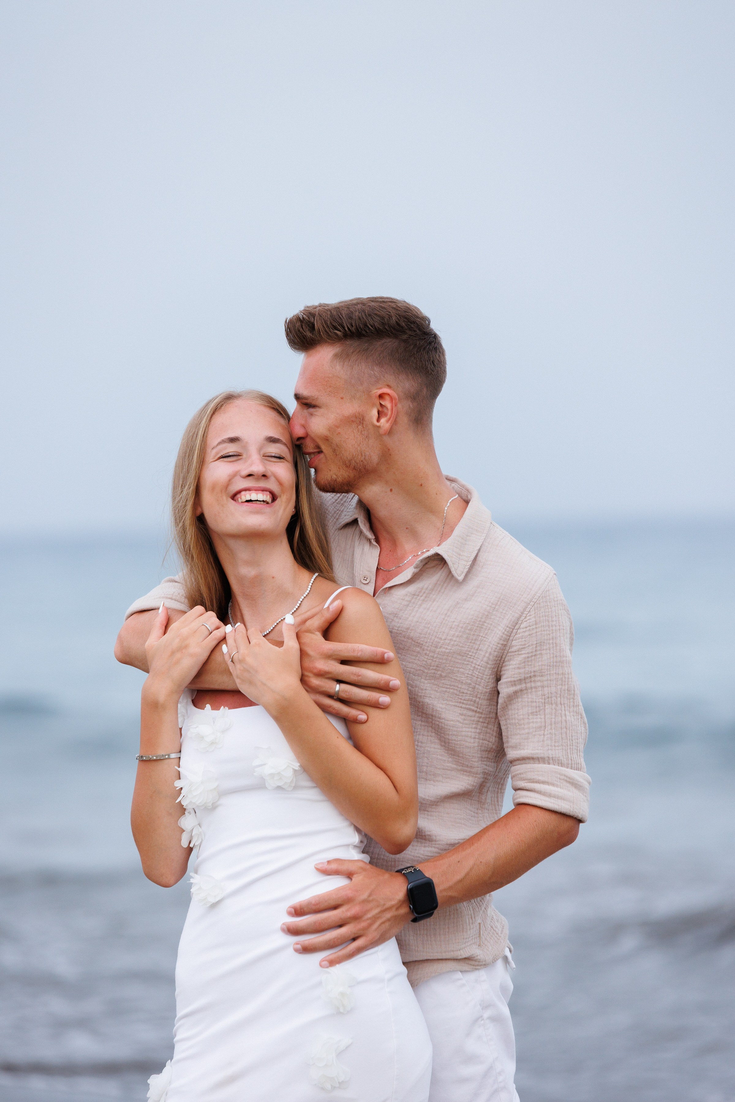 Moody, romantic portrait of a freelancer-style shoot featuring a couple on the dunes at sunset, love and adventure in every frame by Slavik Robtsenkov.