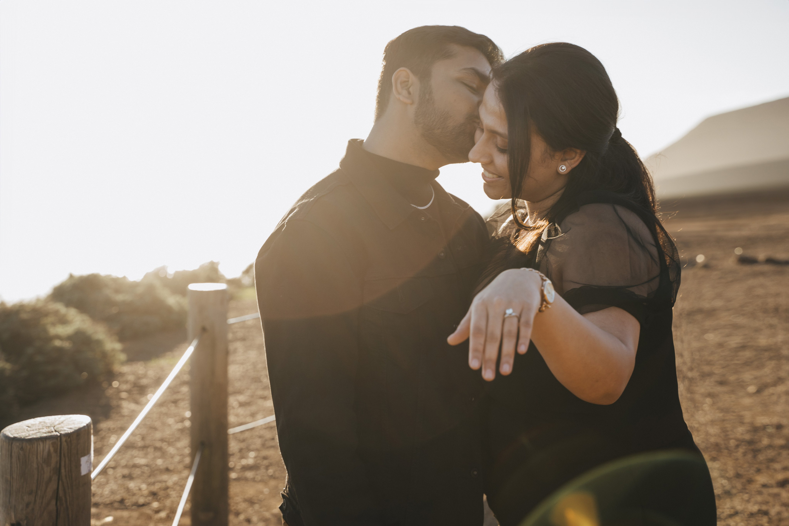 Proposal.  Overlooking the golden San Franisco Bridge sunset with a couple. Photographer Video. 