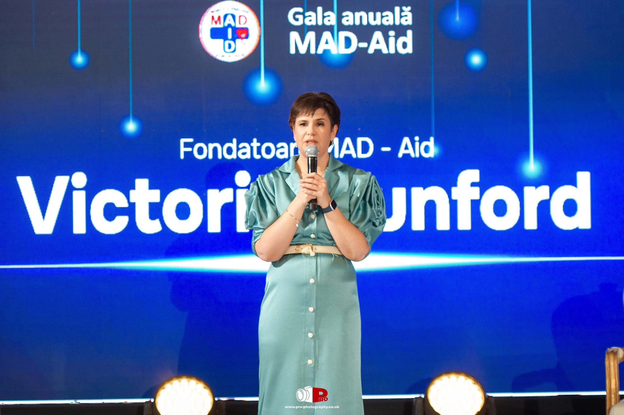 Victoria Dunford, founder of MAD-Aid, addresses the audience at a prestigious gala event.
