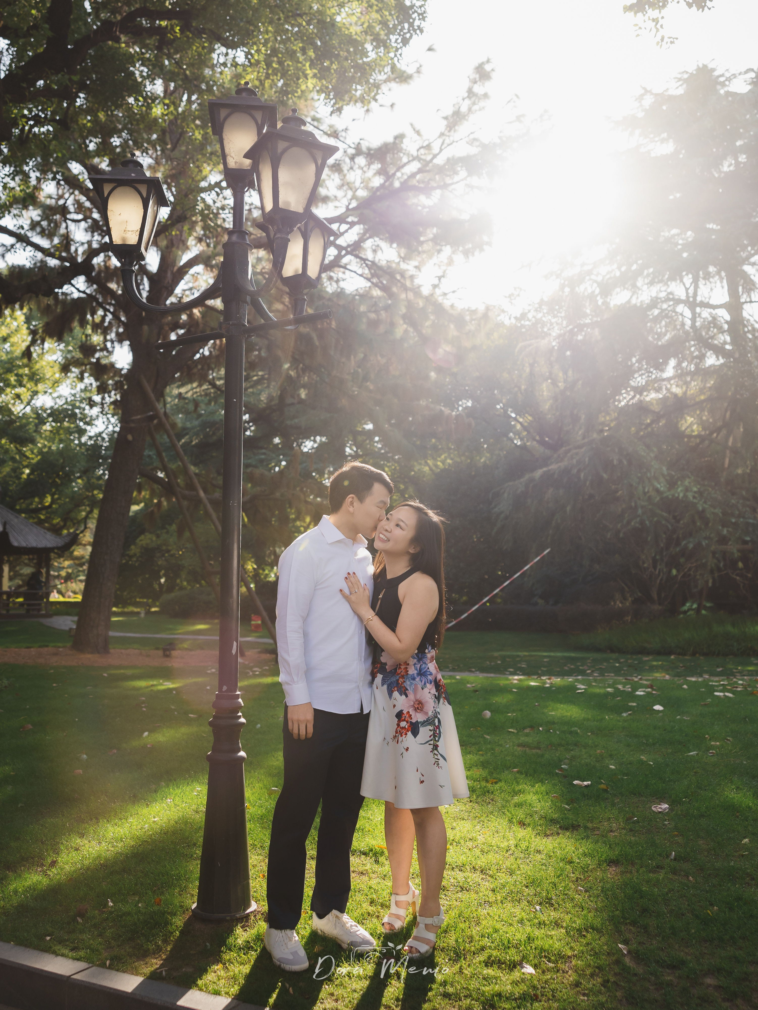 Backlit forehead kiss, golden autumn light, intimate documentary moment