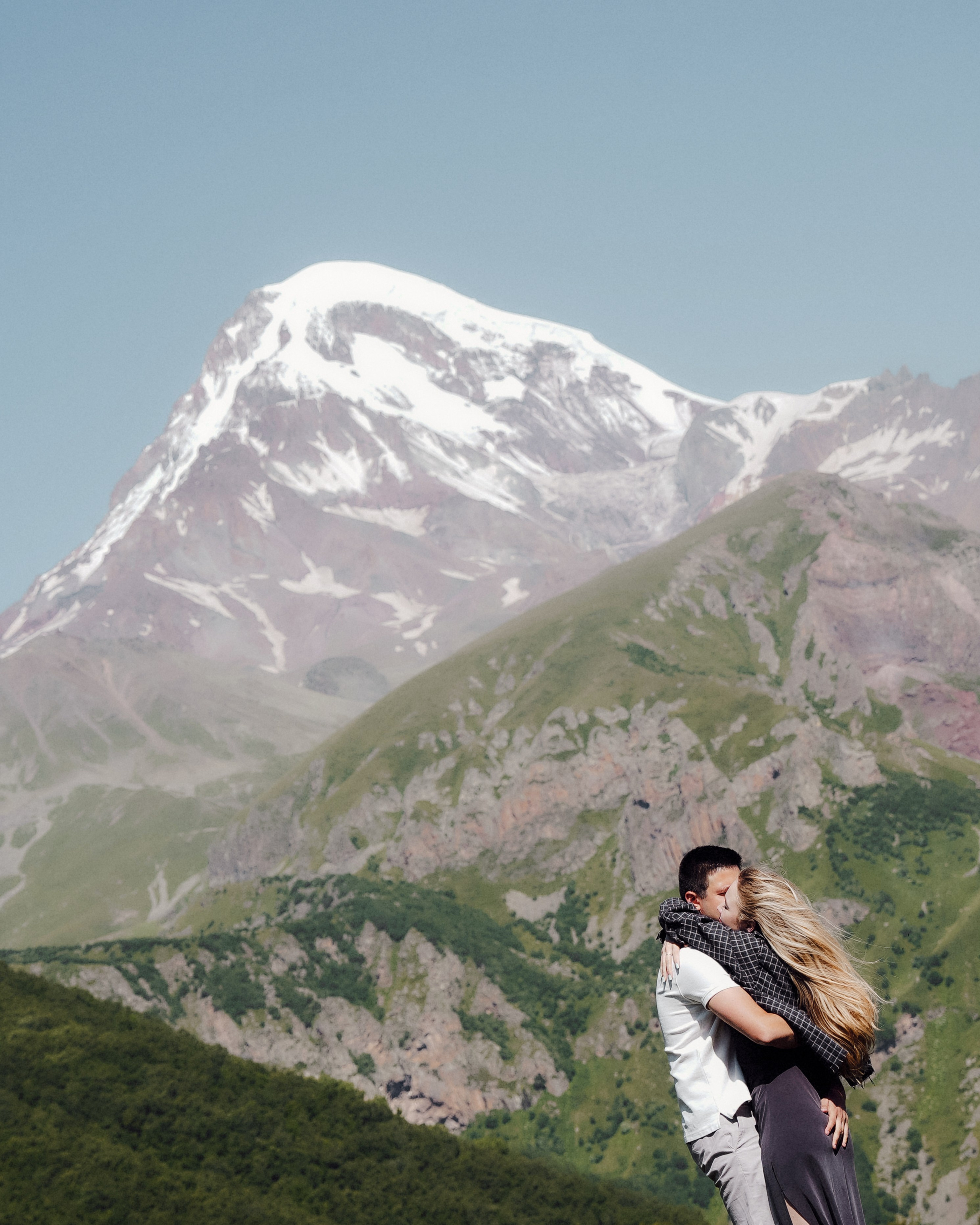 Romantic mountain escape for two, captured in soft golden light in Kazbegi