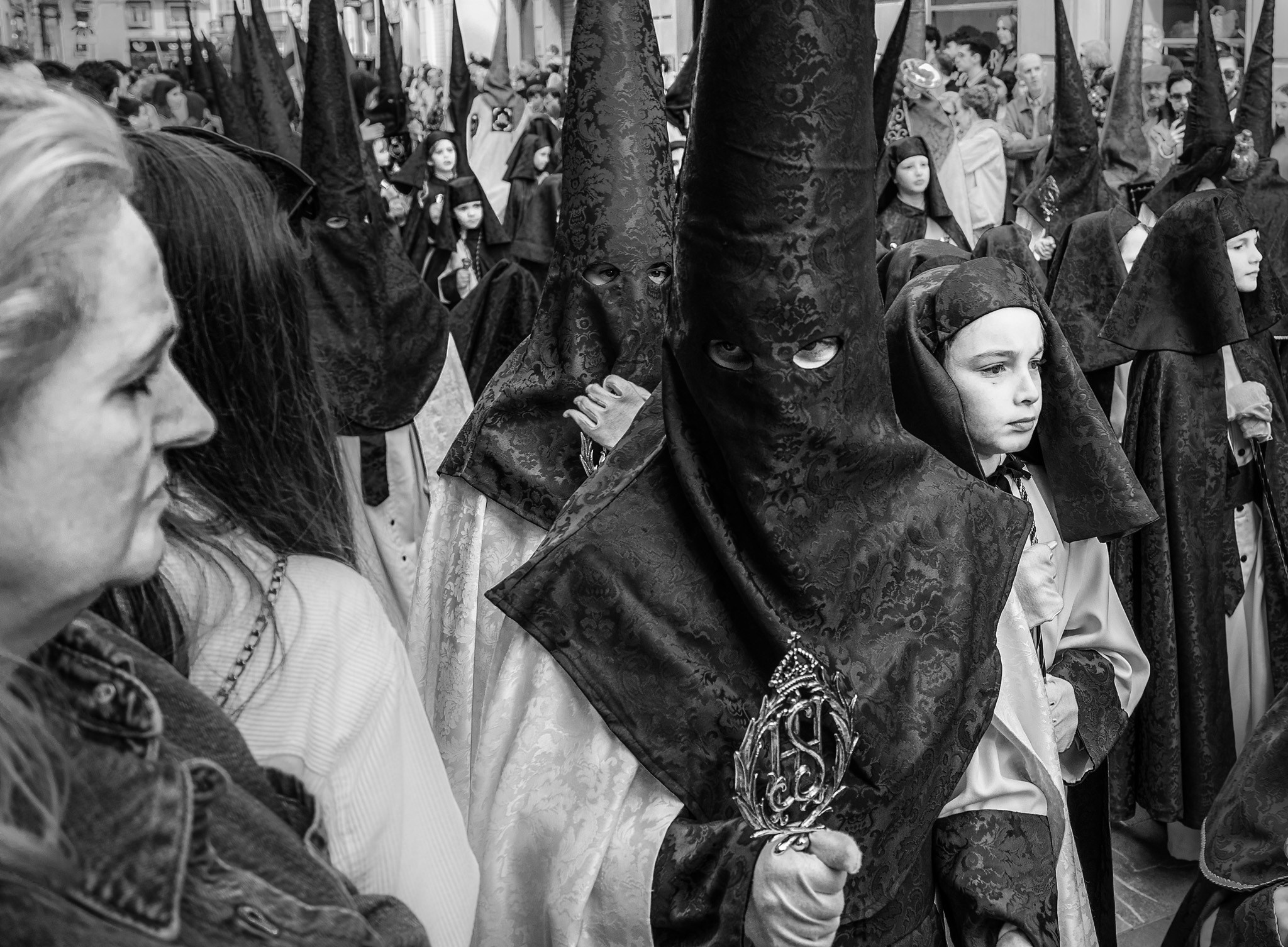Woman watching Holy Week procession during Semana Santa in Malaga, Andalusia, Spain